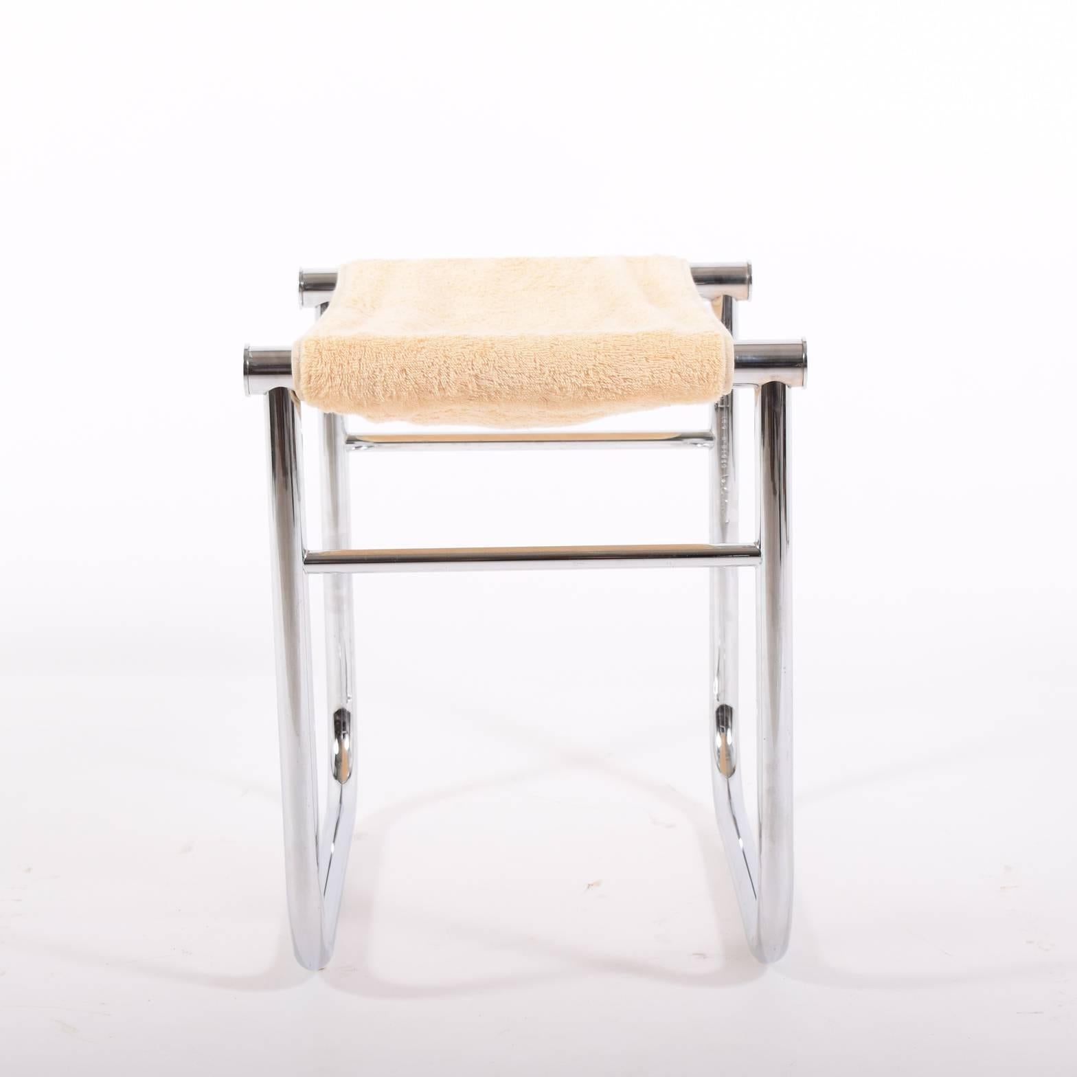 Chrome tubular metal frame seat with removable beige towelling, Signed.