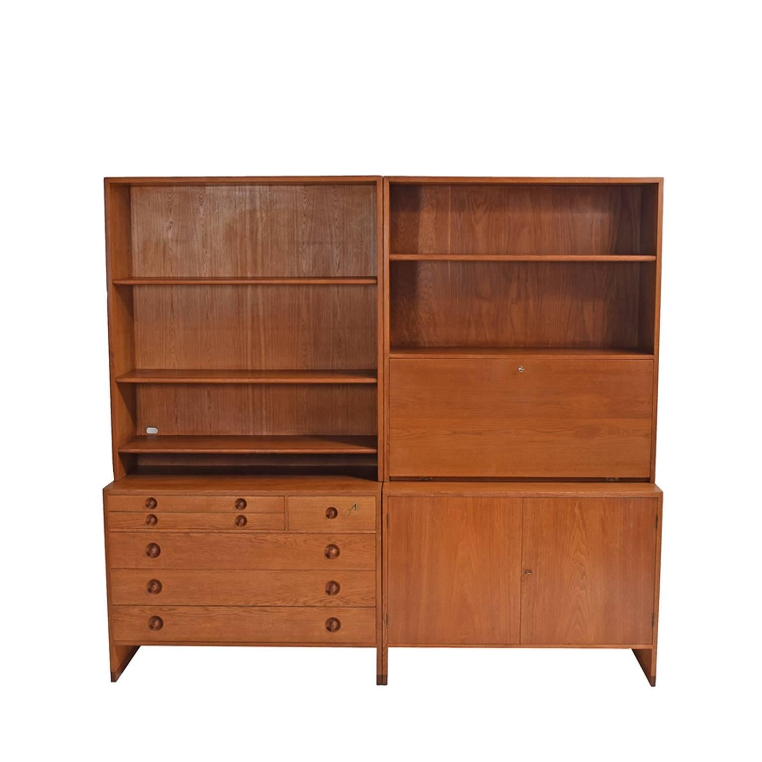 Golden oak wall unit design By Hans J. Wegner In the 1950s for Ry Møbler, bottom units one chest of drawers and the second unit with two doors [two shelves], top units open book shelve and drop desk with light,.