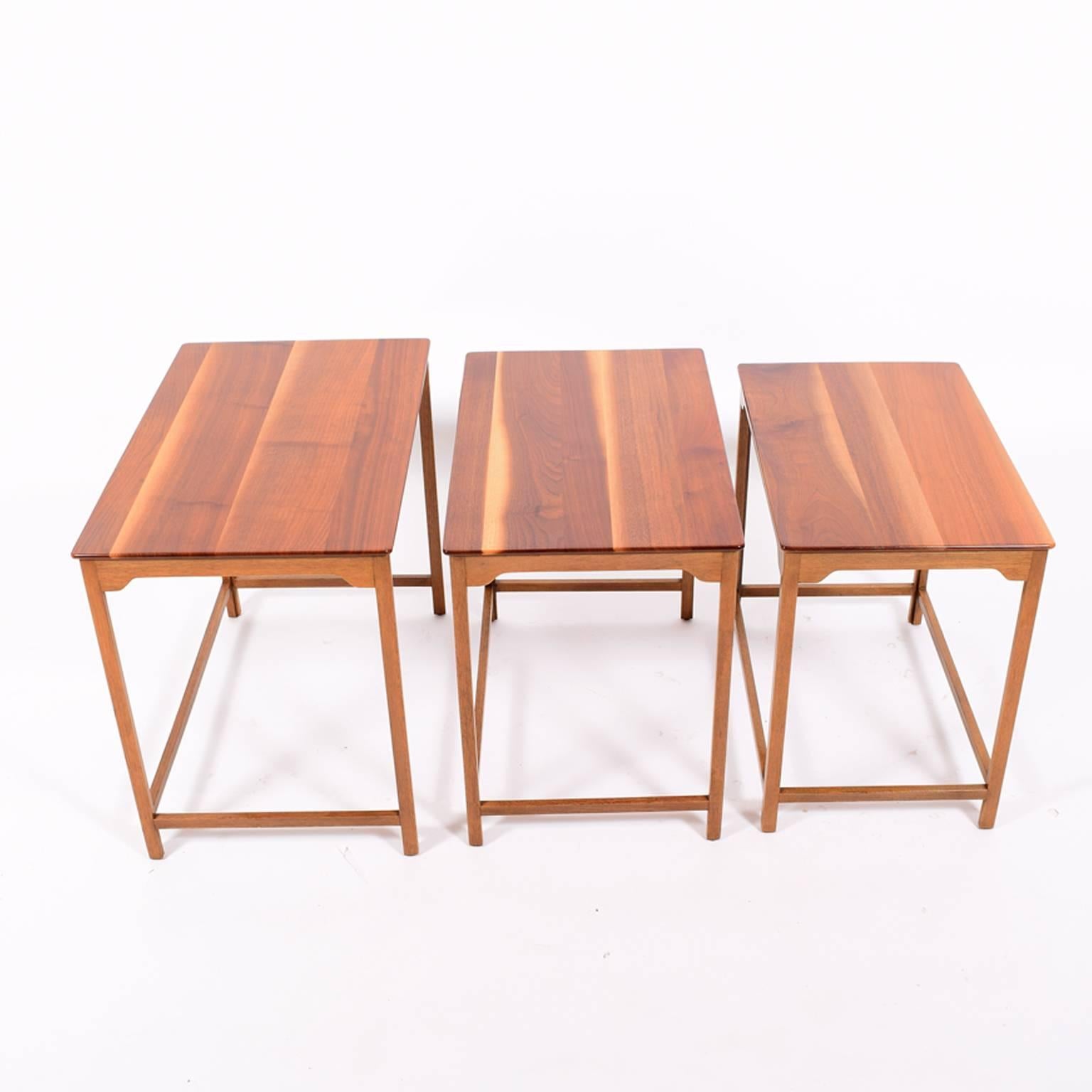 Solid walnut set of three tables designs by Wormley in 1940s, made by Dunbar, gold metal label.