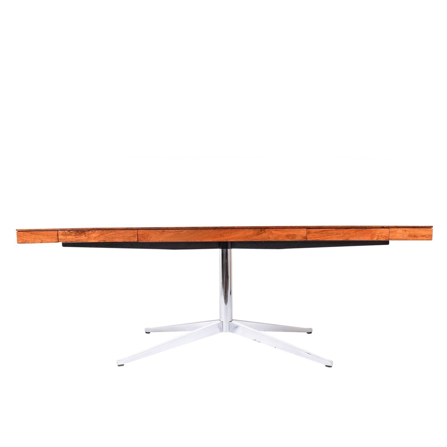 Partner's desk in rosewood, purchased in early 1970s. Box top with two small drawers on each side on polished chrome four star pedestal base. Made by Knoll Associates.