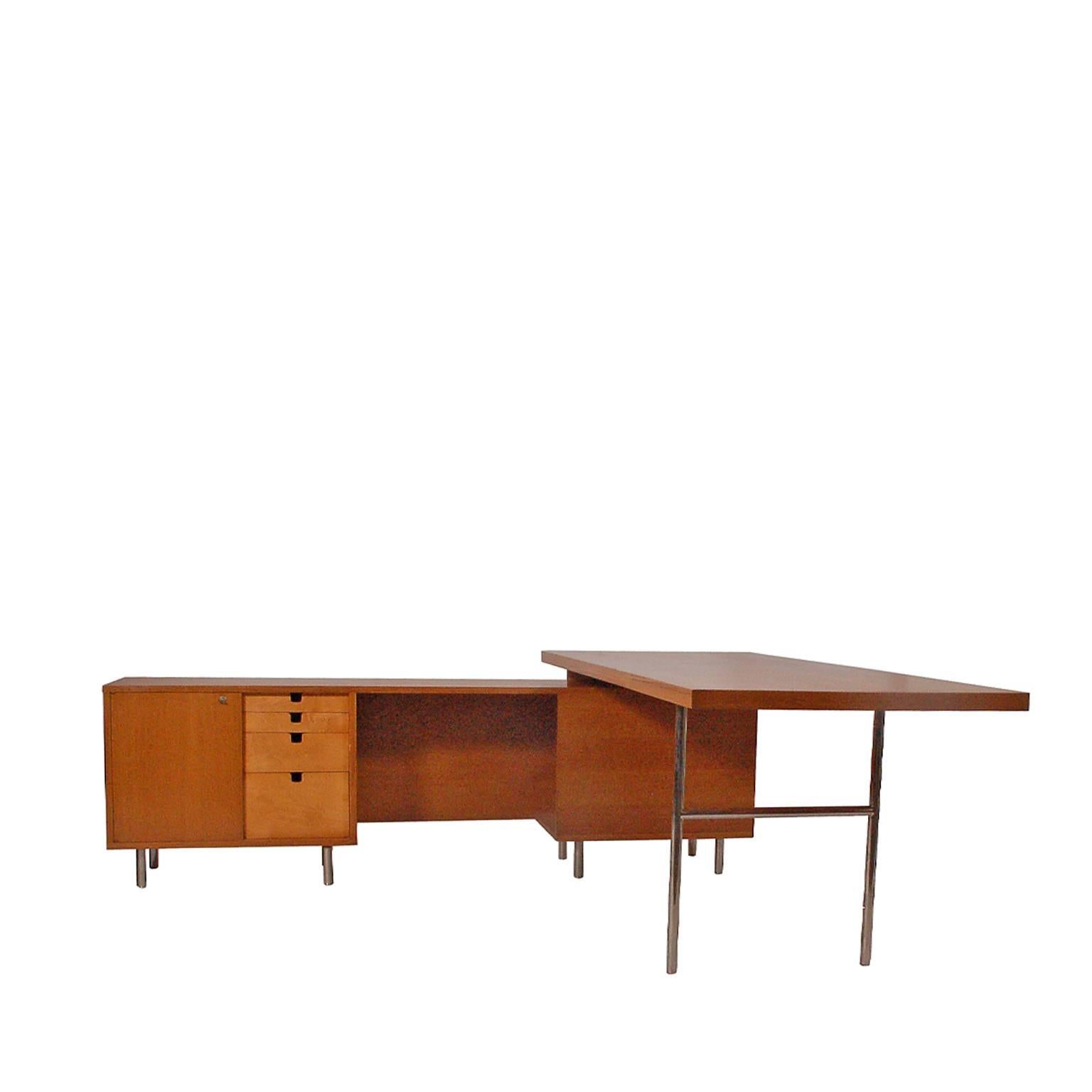 Original production L-shaped executive desk with oak and maple and chrome steel legs and writing support. Original silver label in drawer. 

Work surface measure: 74 in. W x 36 in. D x 28.5 in H. Credenza measurements below.
