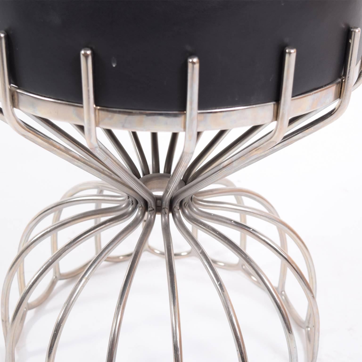 Unique and elegant French stool with bent stainless steel frame. Cushion upholstered with black leather.