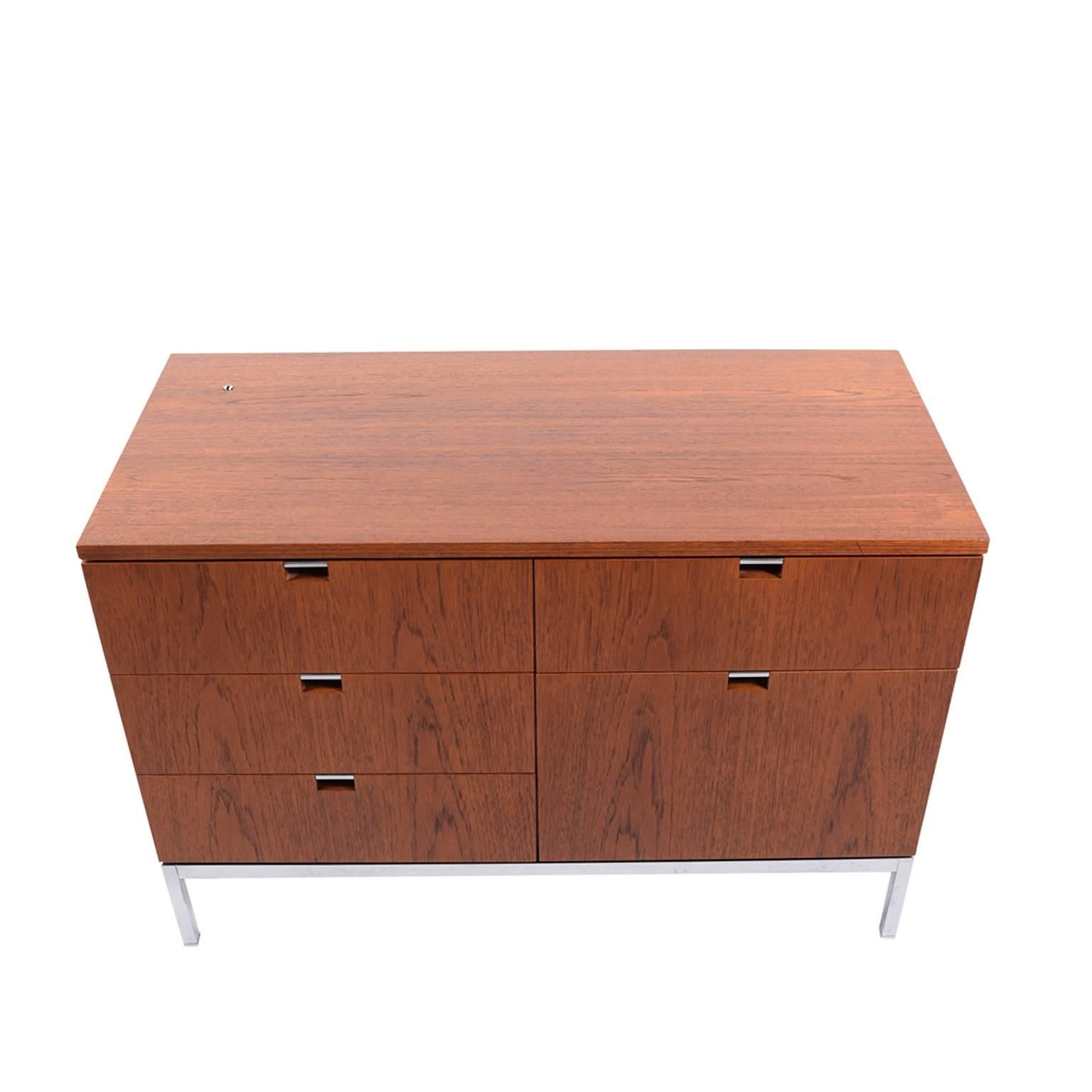 Iconic Florence Knoll design from the executive line, this teak five-drawer chest is freestanding, raised on chrome steel base. Dated 1972. Model 2542M.