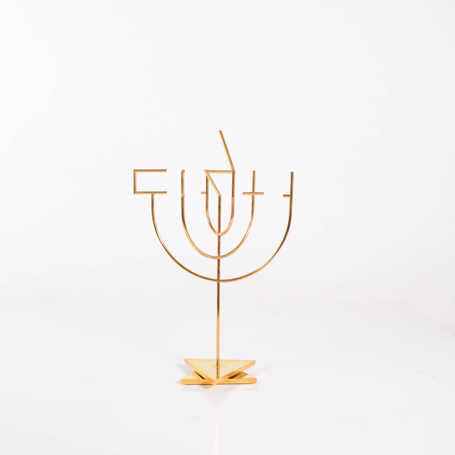 This Kinetic 'Shalom' Menorah was designed by Yacov Agam in 1980. Signed and numbered 126 of 180. Gold-plated brass.