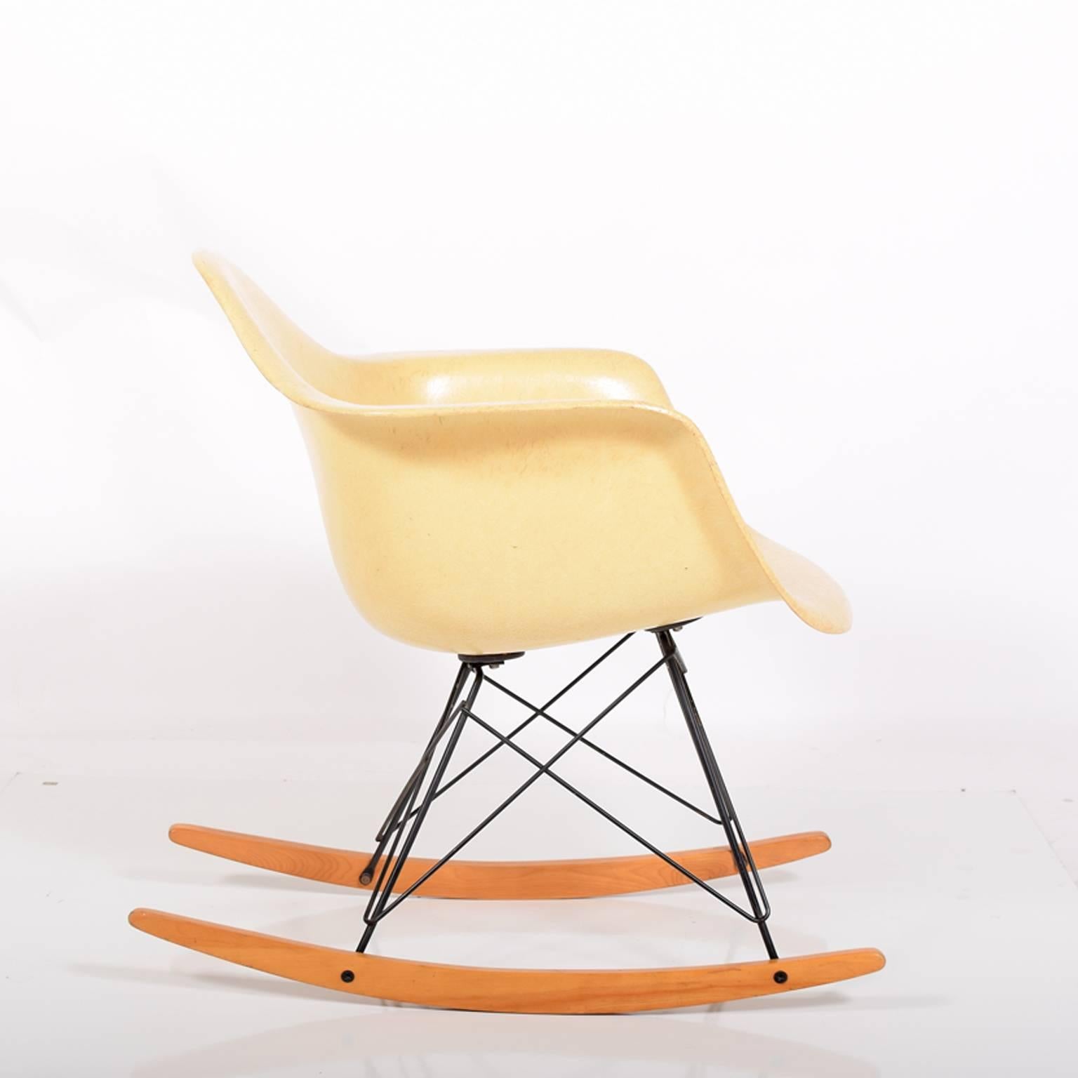 Original fiberglass armed shell on black wire base with birch rocker struts and large rubber mounts. Marked on bottom, Herman Miller. The chair was on carpet most of its life.