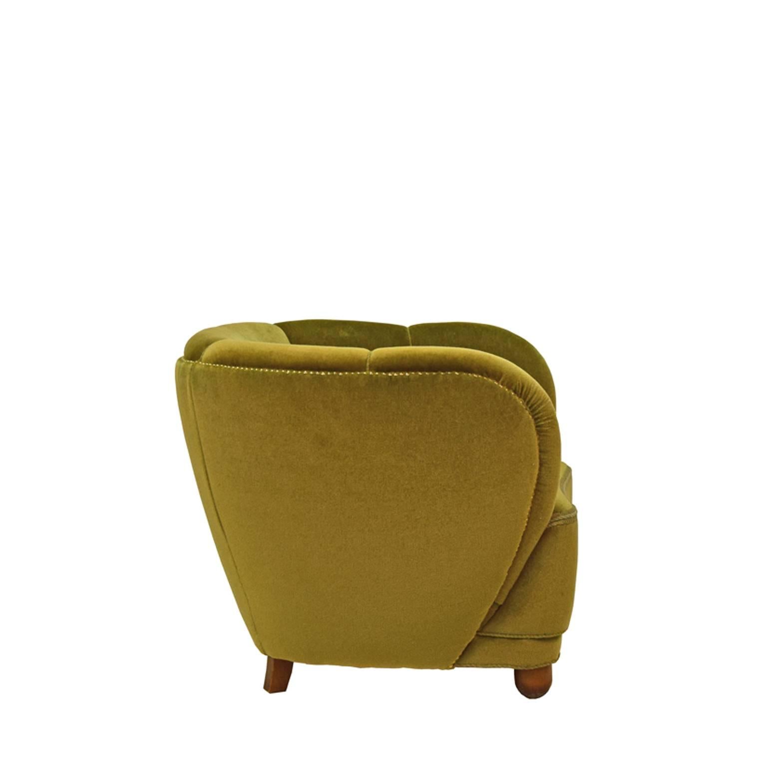 Danish easy chair on solid beach legs with green velour upholstery.