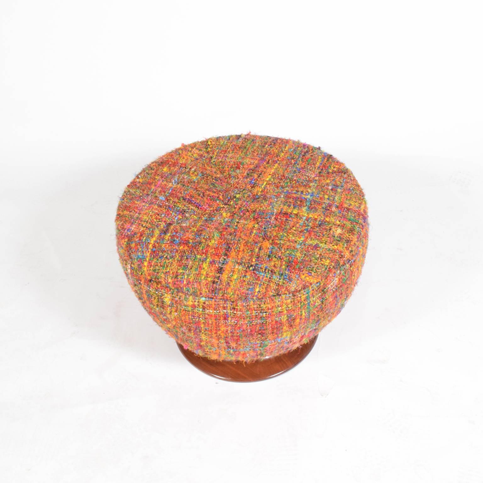 American designed 1930s large round upholstered stool or ottoman with removable lid for storage on solid walnut base. New heavy multi color textured fabric.