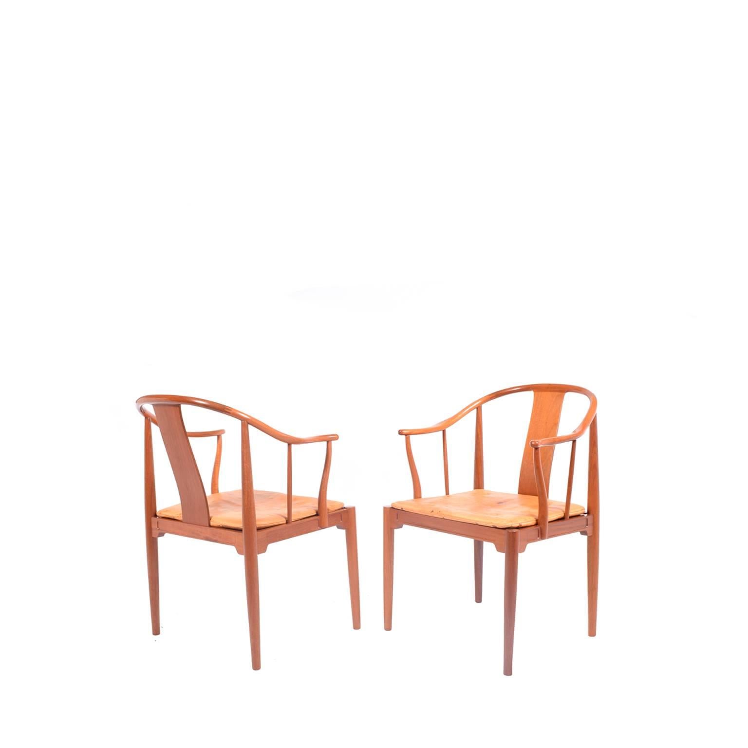 Solid mahogany armchairs with natural leather cushions designed by Hans Wegner for Fritz Hansen in 1944. Inspiration came from a 1400 Chinese chair he saw in a museum.