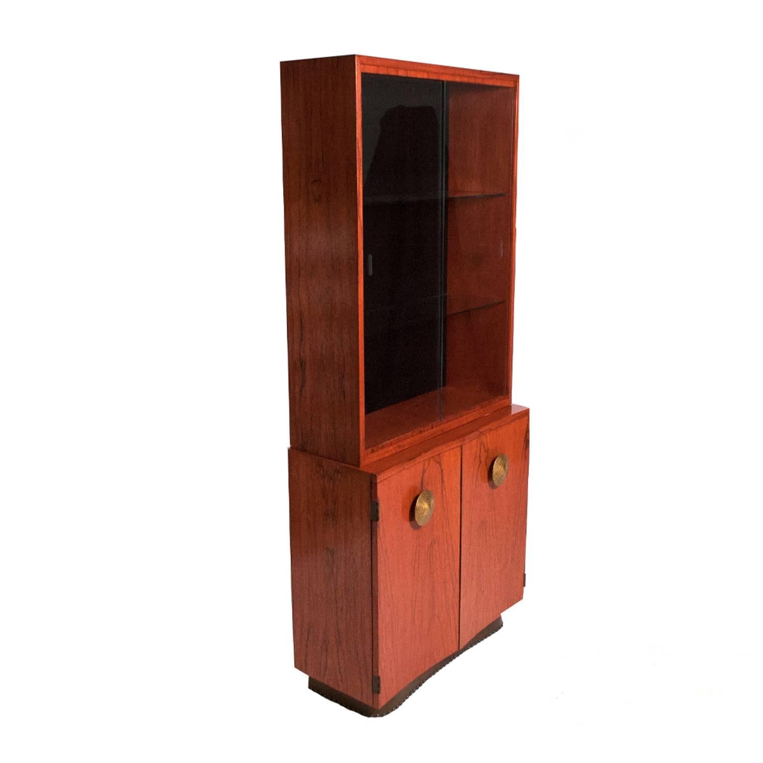 China cabinet with sliding glass doors and two-door cabinet below. Paldao wood cabinets and metal pulls specifically designed for this Paldao group. Cabinet has one wooden shelf, top has two glass shelves. Made by Herman Miller.
Design number stamp