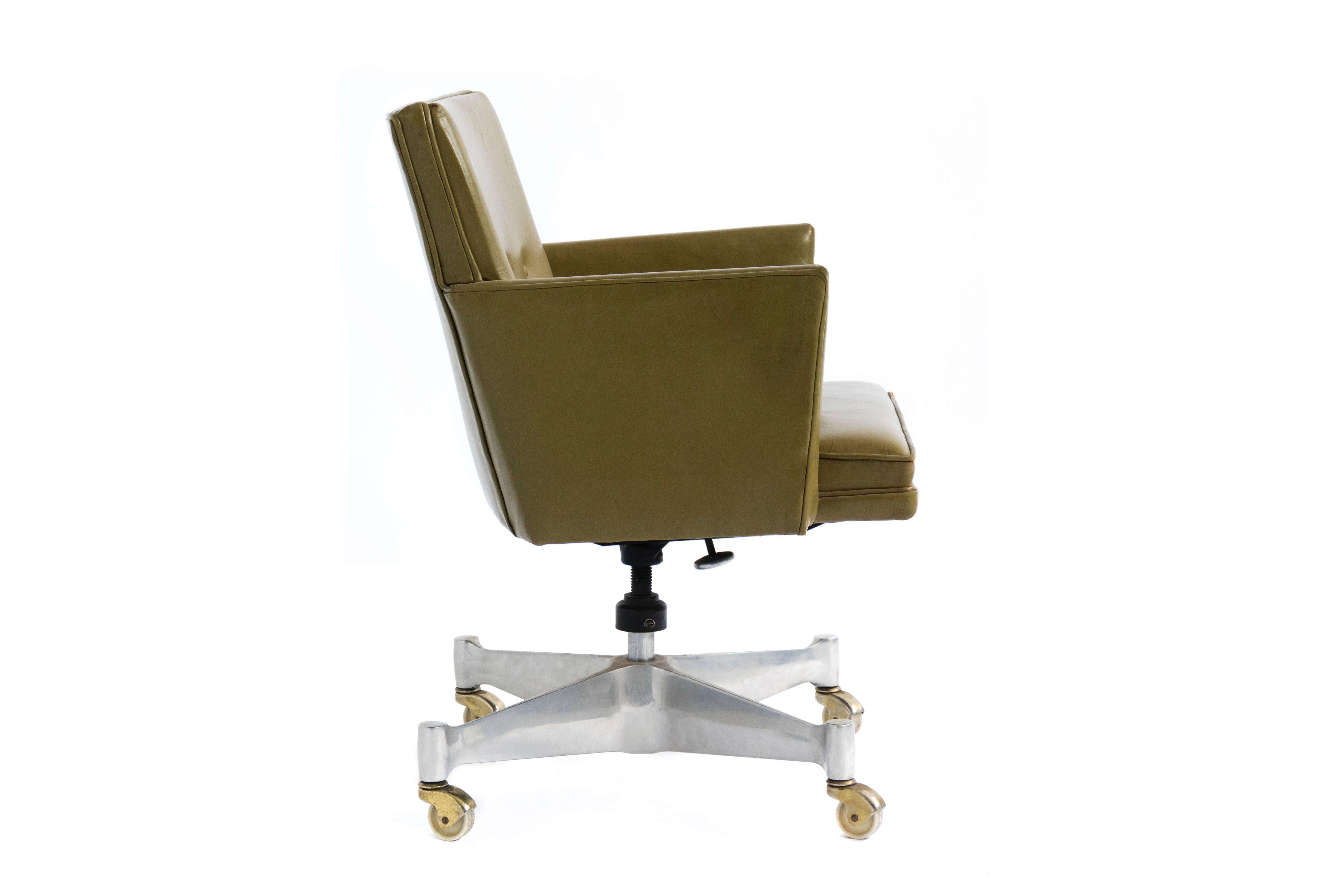 Upholstered green leather with aluminum base on casters. Tilt and swivel adjustments. Leather is original and has been restored on arm edges.
Foil label pictured.