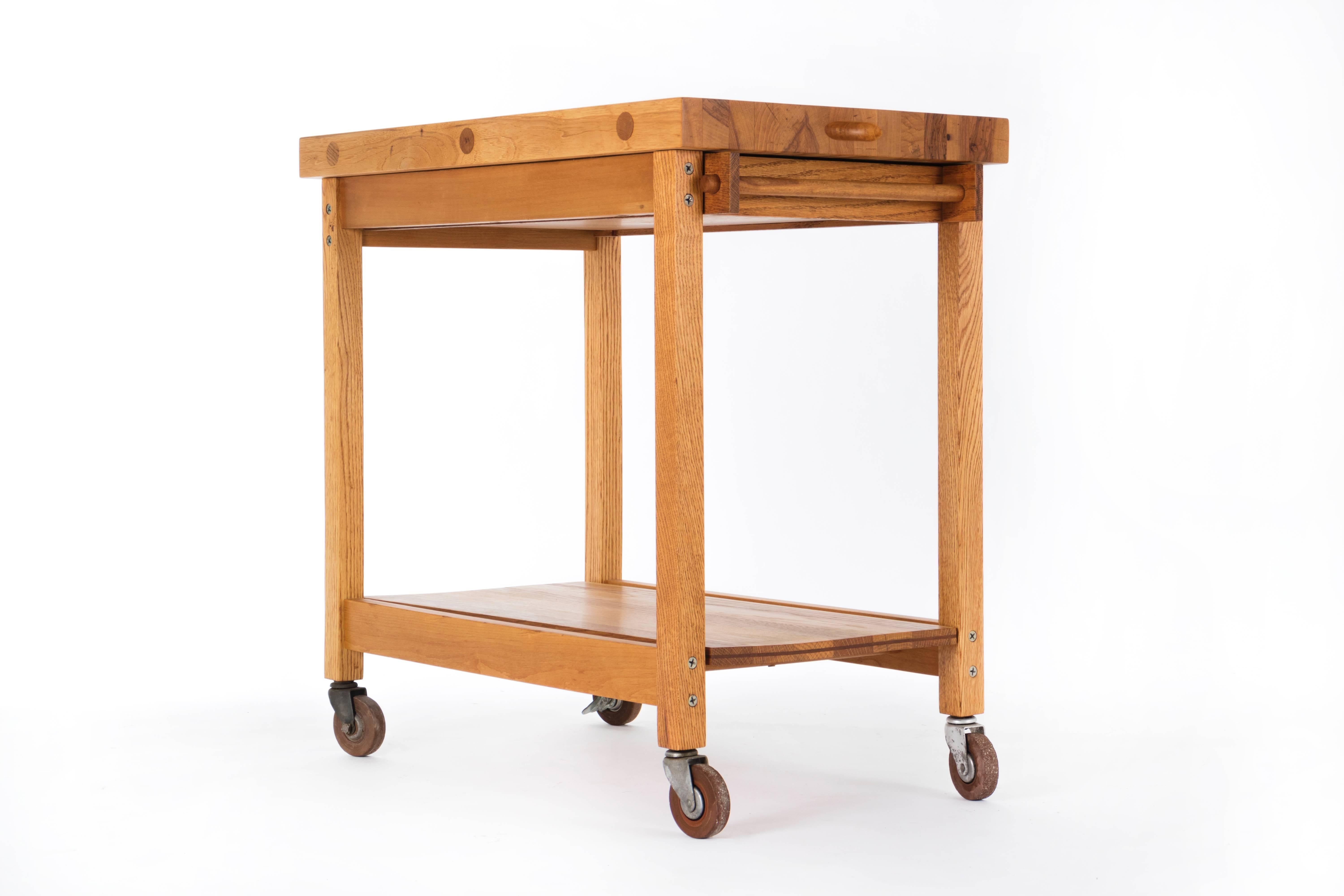 Chopping block bar cart by Bill Saunders on rubber wheels with extending serving drawer. California Design 9 Pasadena Art Collection similar version.
Great utilitarian piece.