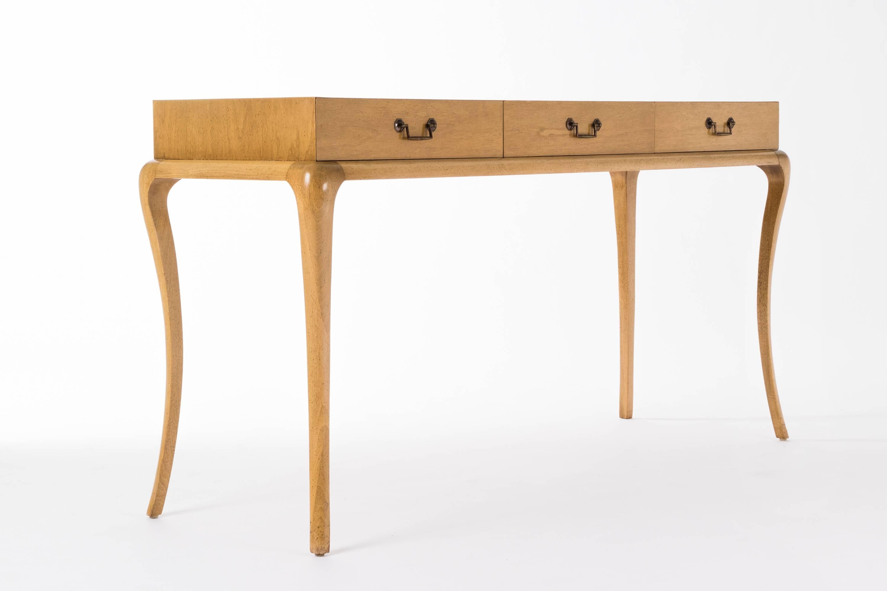 Parzinger originals, three-drawer console, lacquered maple wood with curved saber legs and brass pulls.
  