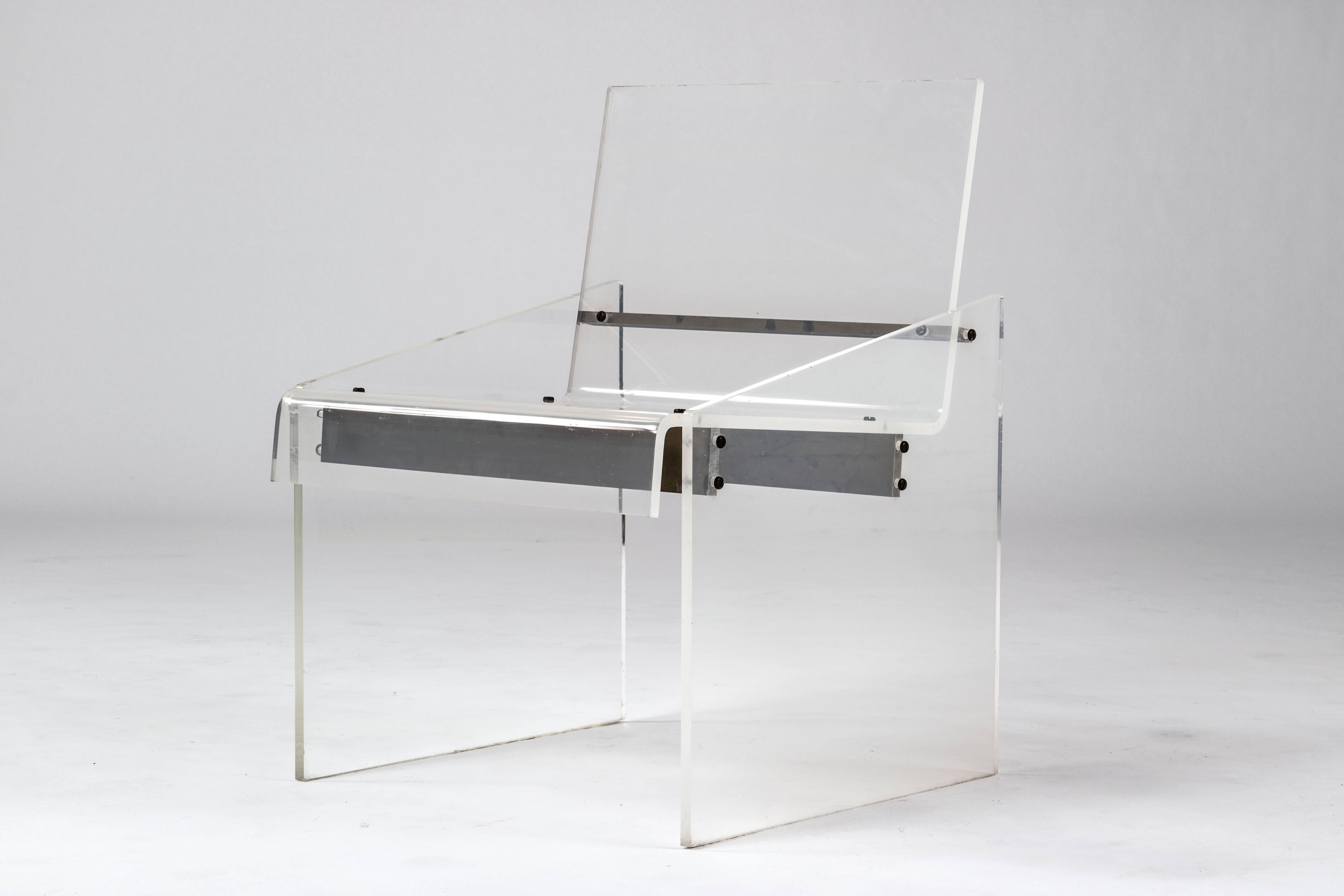 Lucite chair with brass horizontal supports.