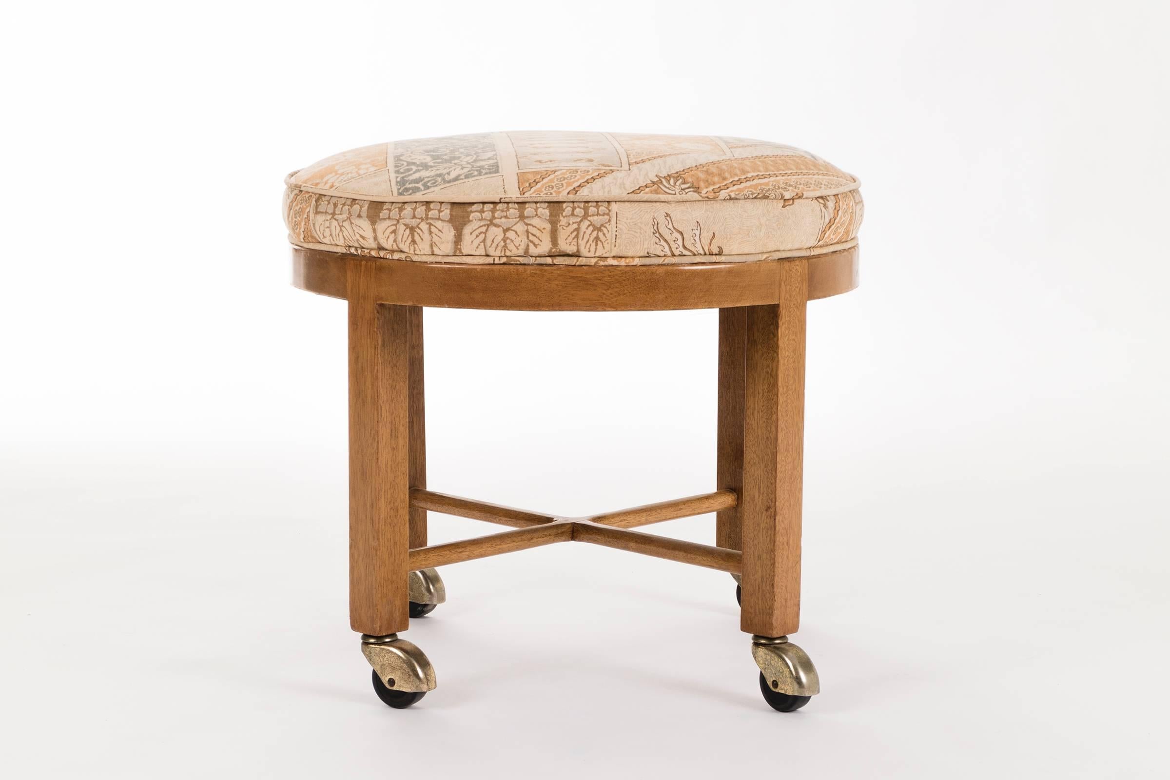 Mahogany stool on casters. Original upholstery.