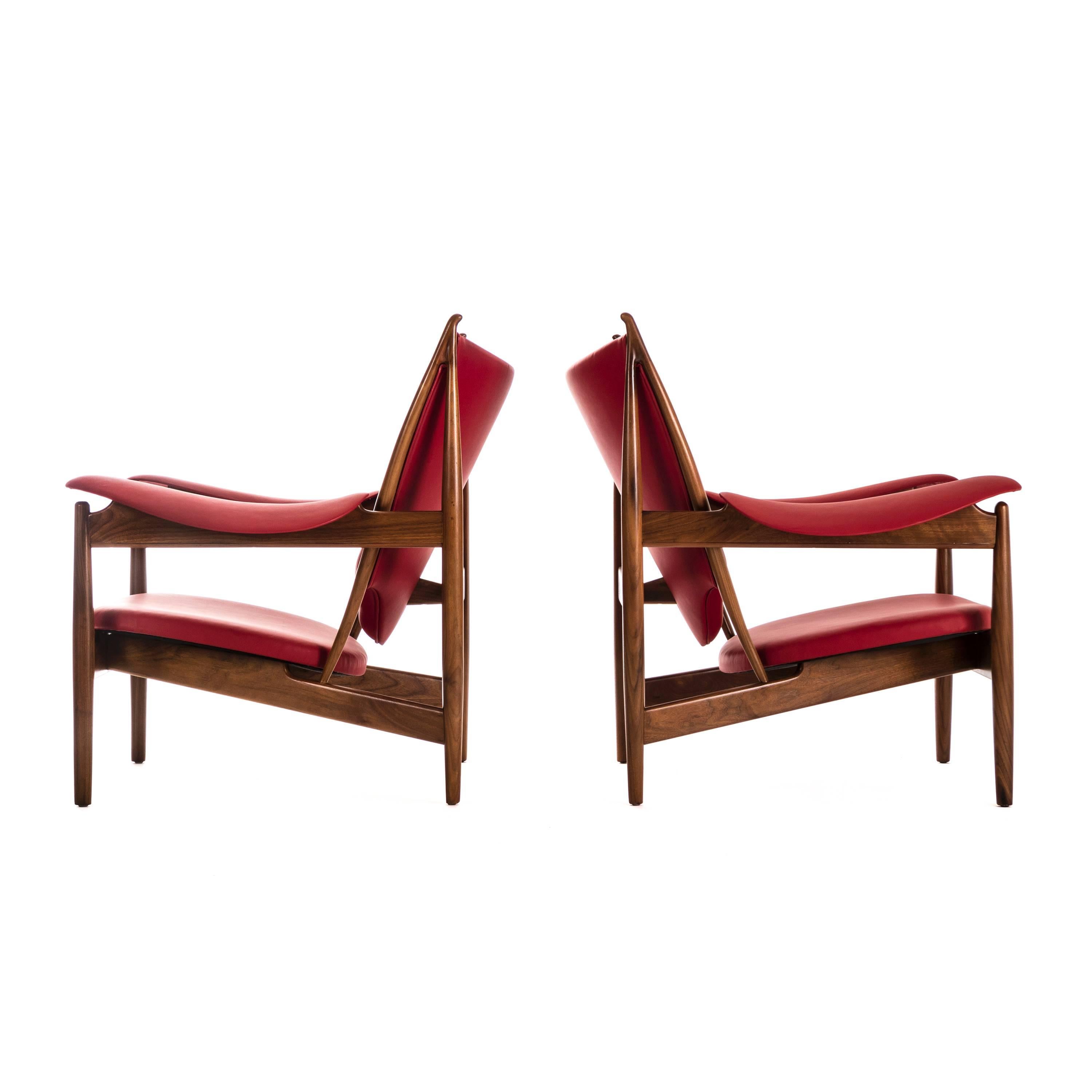 Pair of Finn Juhl Chieftain lounge chairs for Baker Furniture Company. These are a 1990s production of Finn Juhl's original 1951 design. Metal label on underside read [Finn Juhl Baker Furniture]. Reupholstered with Edelman leather.