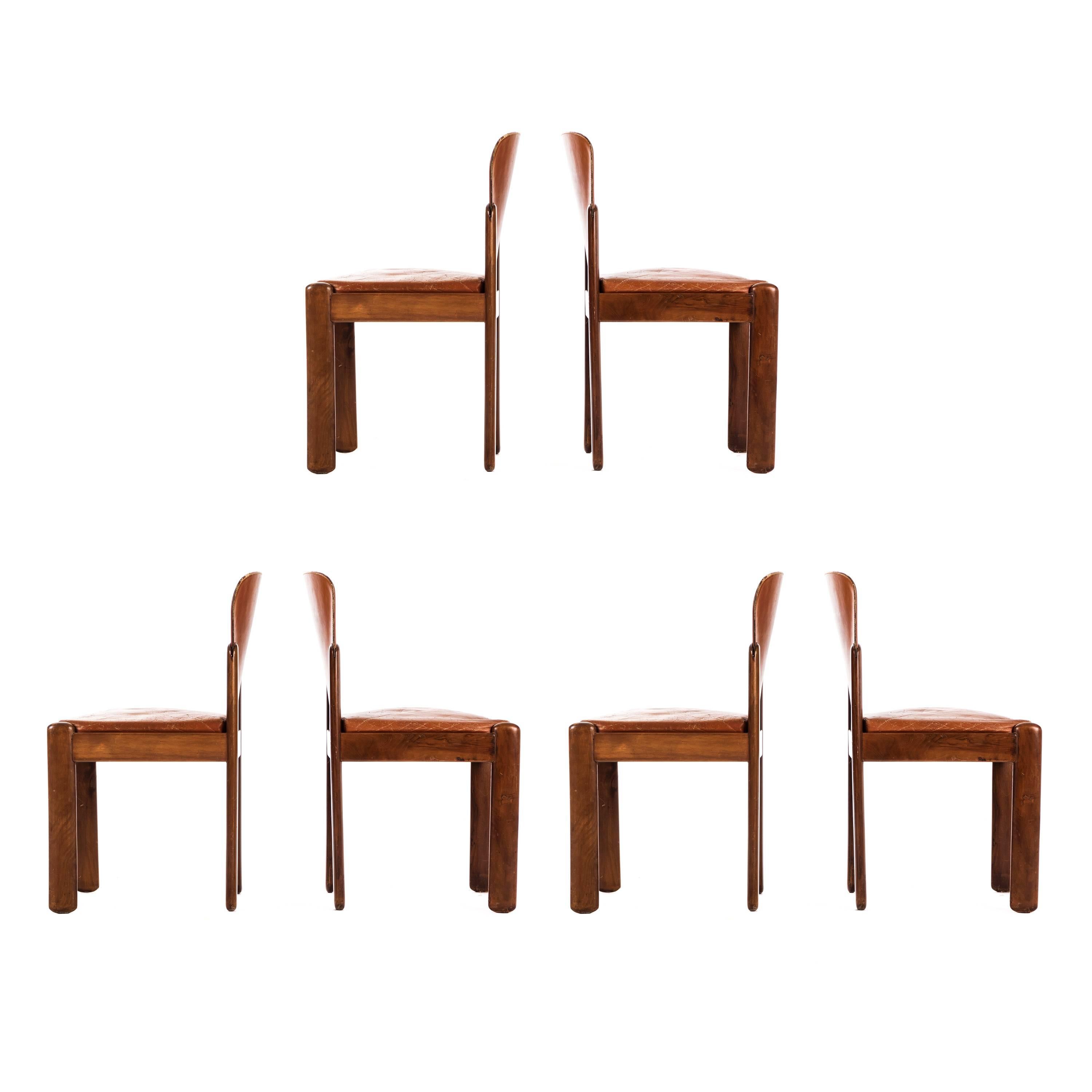 Set of six Silvio Coppola 330 chairs for Bernini. This set of dining chair have a simple stained beech frame with a foam padded leather seat with leather back. The chairs have strong an architectural structure with angular legs and curved backrest.