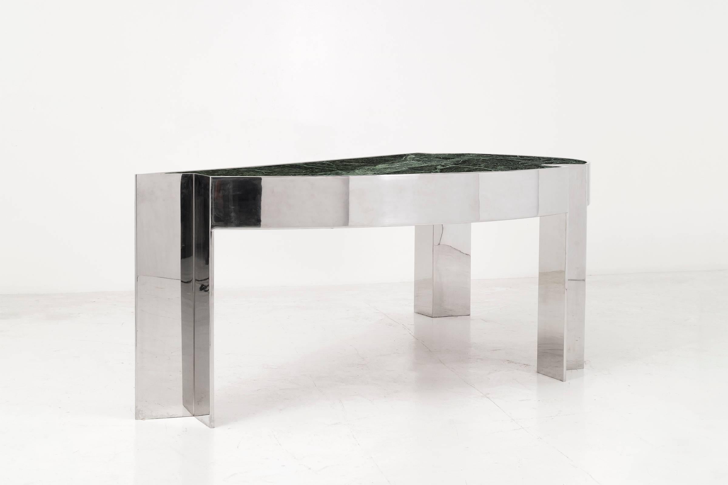 Arced desk with a polished steel frame and verde marble top. Two drawers with laminate fronts and wood inner.

Armchair clearance height: 27 in.