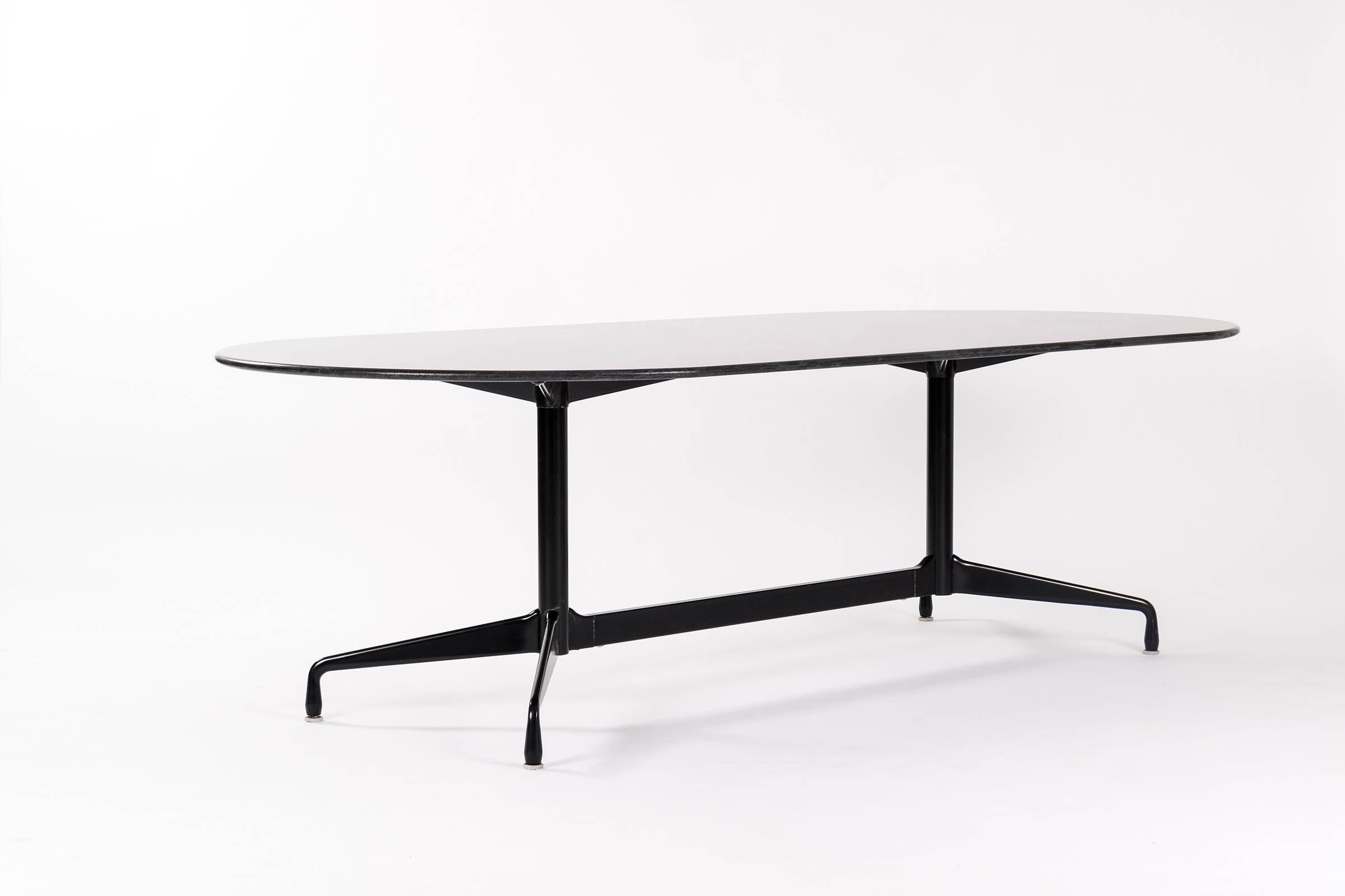 Custom segmented base table. Racetrack shaped black granite honed top with bull nose edge. Matte black steel and aluminum base.
