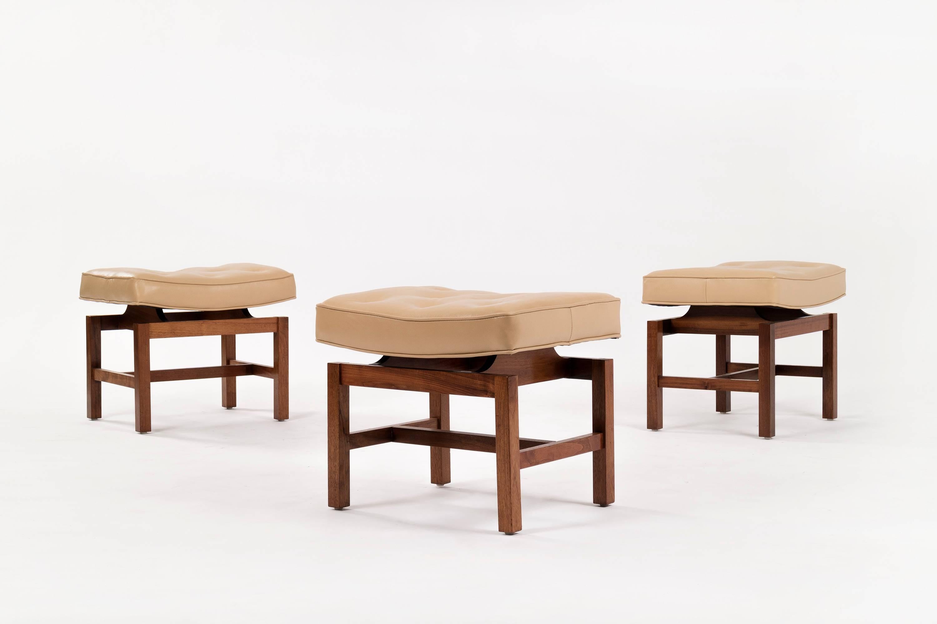 Risom for Risom Inc. Set of three button top ottomans with walnut frames in natural oil finish.