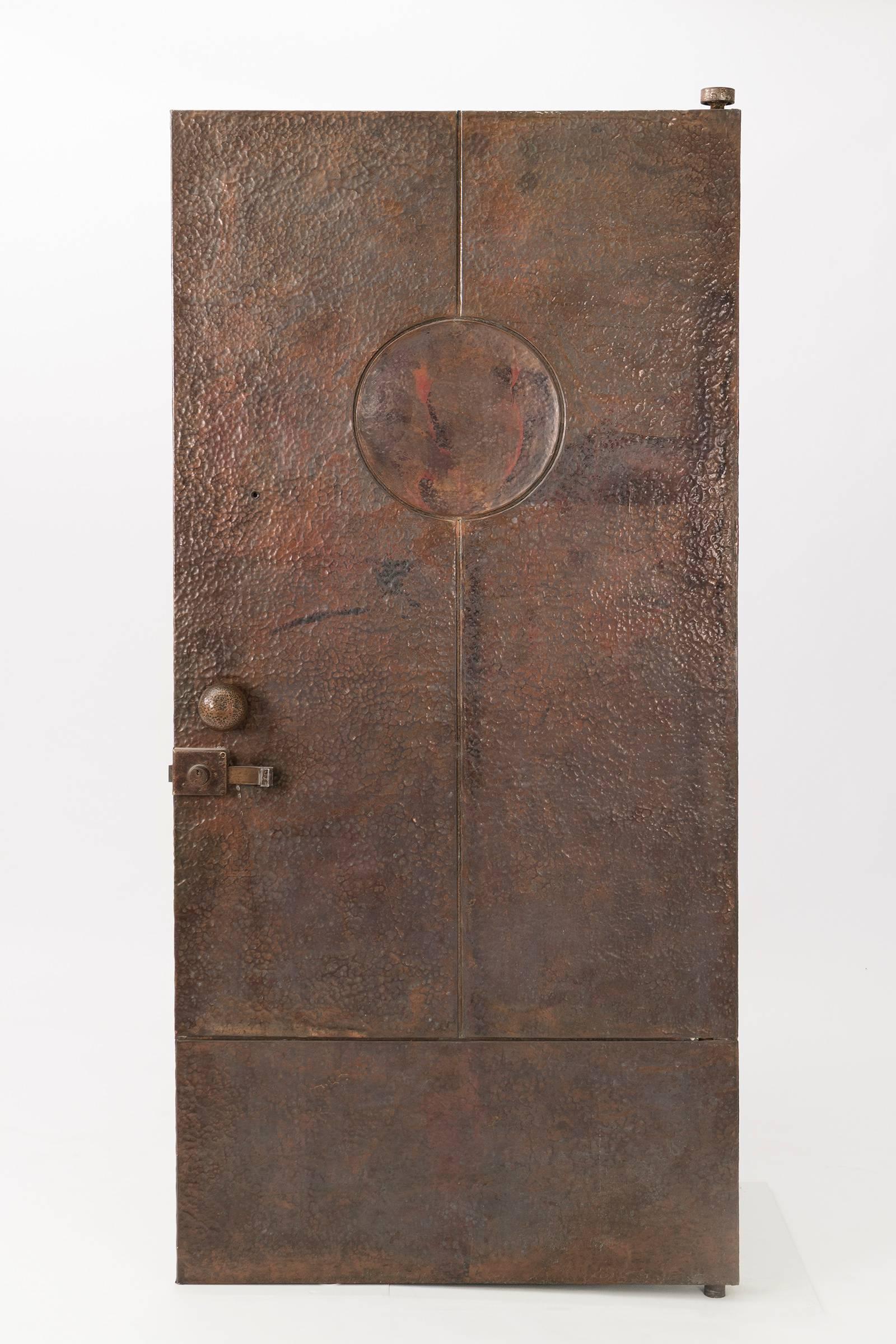 Important custom door designed by Ricardo Legorreta for the residence of Ricardo Montalbon's residence in the Hollywood Hills. This monumental door is made from hand-hammered copper over wood with solid copper door knobs and slider latch with lock