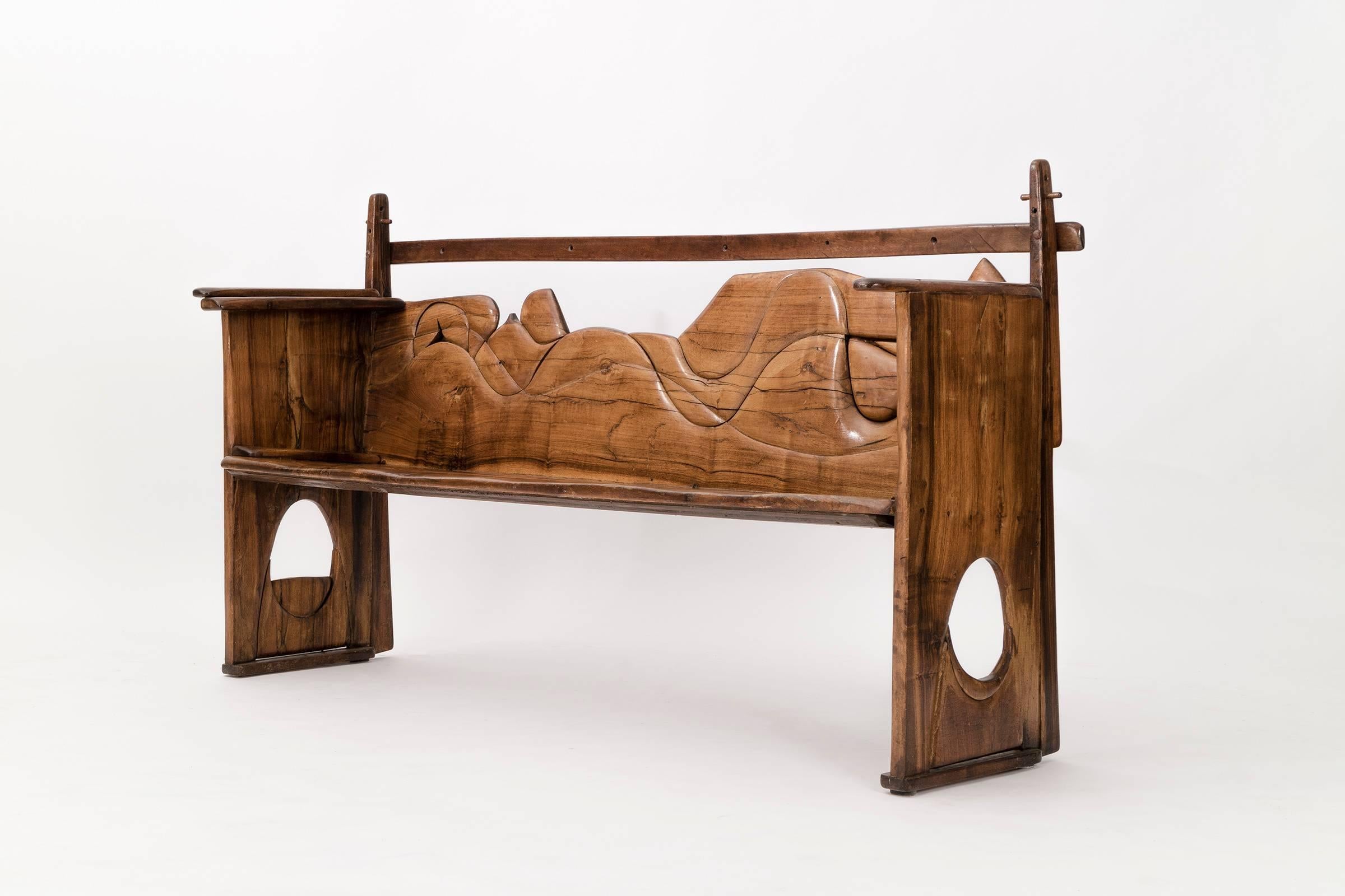 De Swart Bench-This bench made with walnut hand-carved by the Artist has many playful design details, the adjustable support bar in the back, arms with holes and round cutouts on sides makes this bench visually intriguing and esthetically
