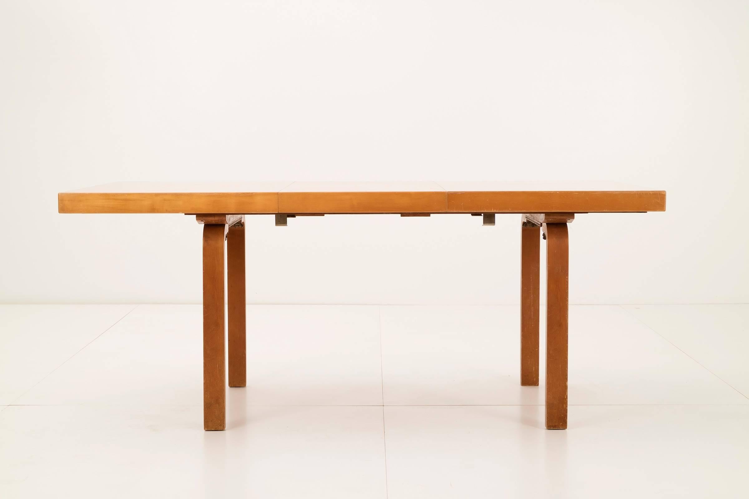 Alvar Aalto extension dining table for Arteck. Model H92. This dining table included two table leaves, 19.75 in. each that extend to 90.5 in. When table is not extended there is a beneath the top to store the leaves.