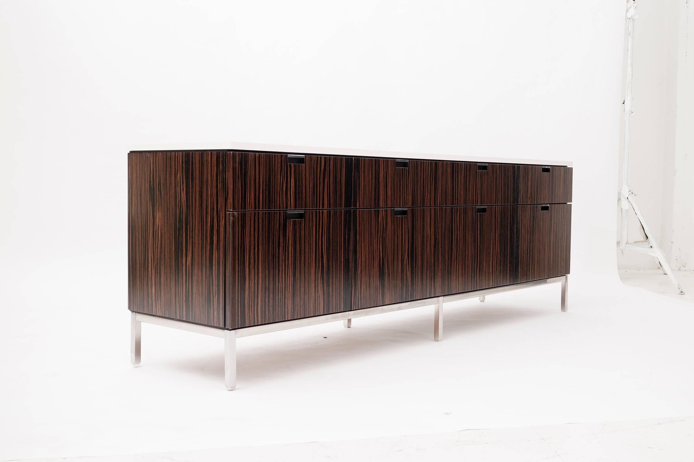 Florence Knoll for Knoll International. This special ordered book-matched ebony stripped veneer credenza features eight drawers with a marble top and chrome-plated base with adjustable feet.

This item is currently on view in our NYC Greenwich