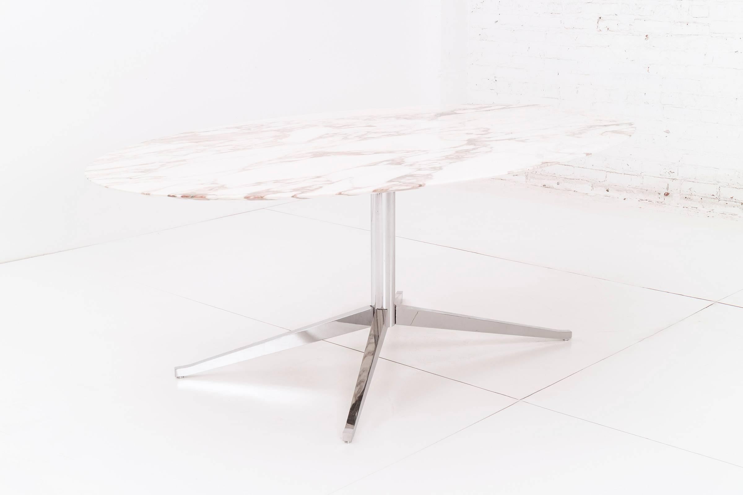 Chrome-plated steel pedestal based table with calacatta marble top. This versatile piece can be used as a dining table or desk.