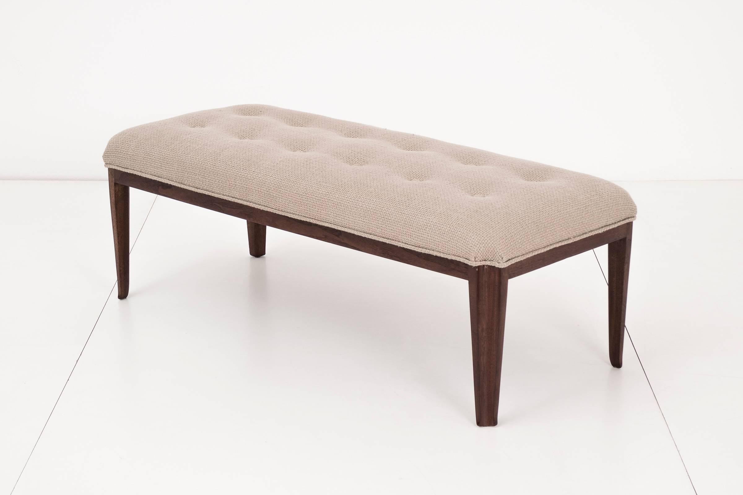 Paul Laszlo bench newly upholstered with great plains woven fabric. This piece has a solid shaped concave tapered mahogany legs and tufted cushion seat with channel seam detail around the seat.
 