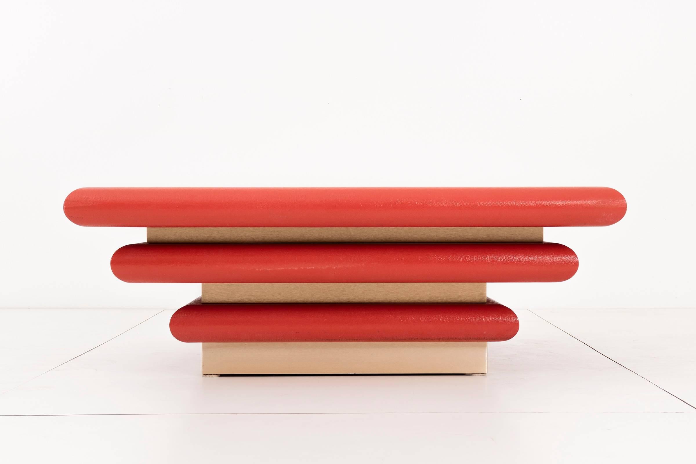 Tri-tier table constructed of wood wrapped in red painted burlap textile. Each tier has a satan golden hued metal base. Origin unknown.
 