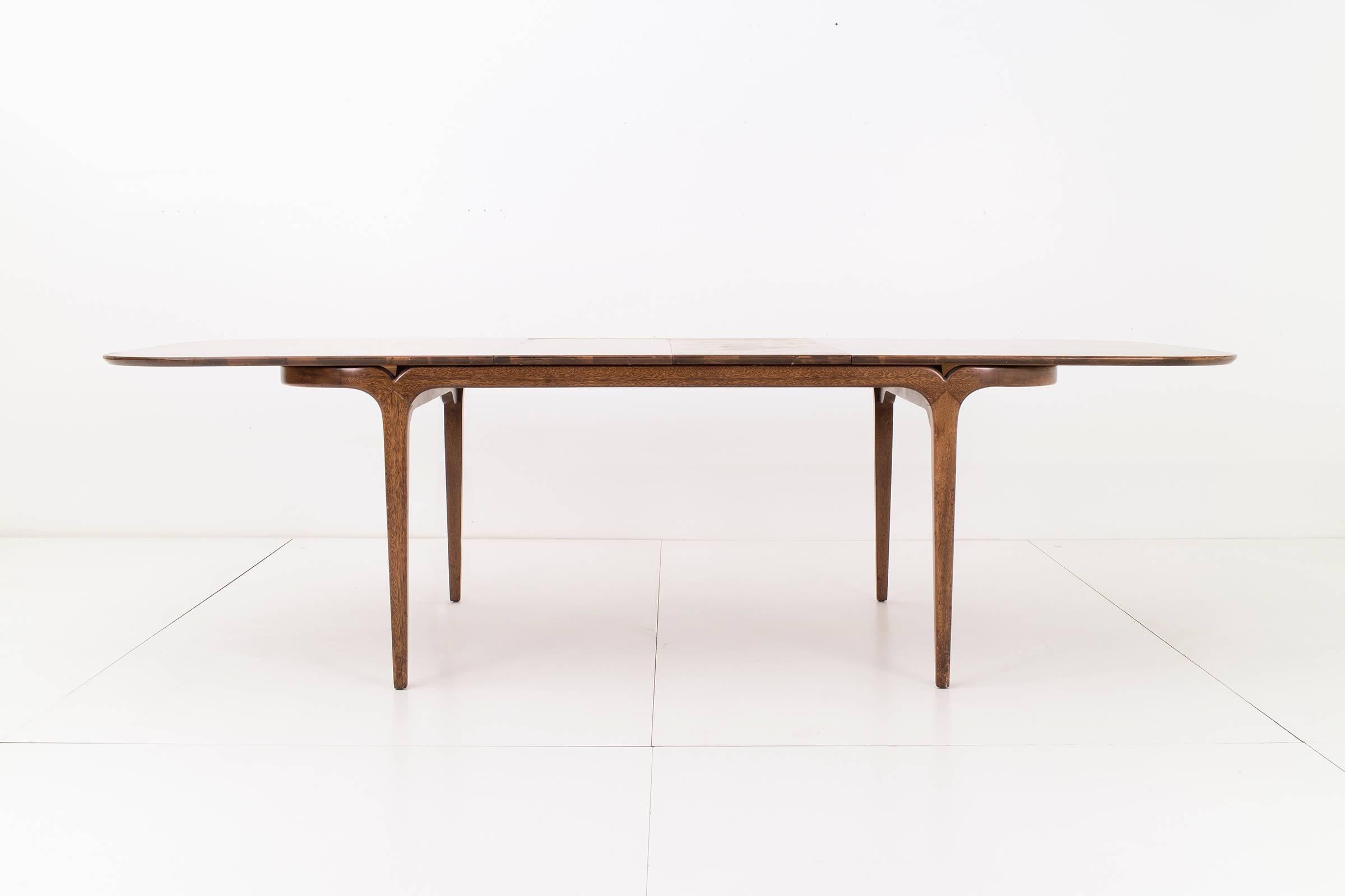 Mahogany dining table with rounded corners. Tabletop extends with two 15
