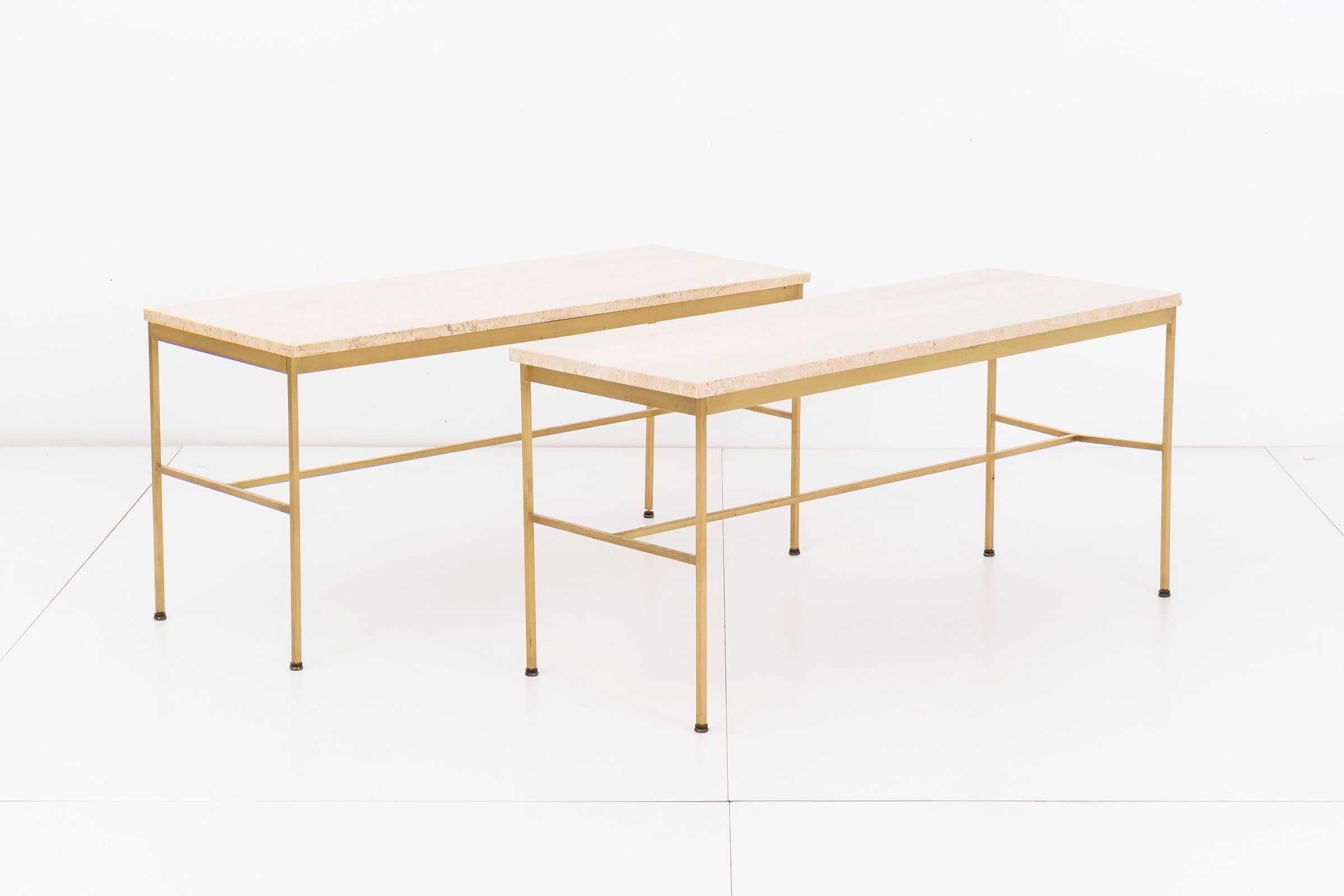 Paul McCobb for Directional. Pair of model 8704 console tables. Square tubular brass frames with travertine top. Patina on brass consistent with age and use. Stool sold separately.