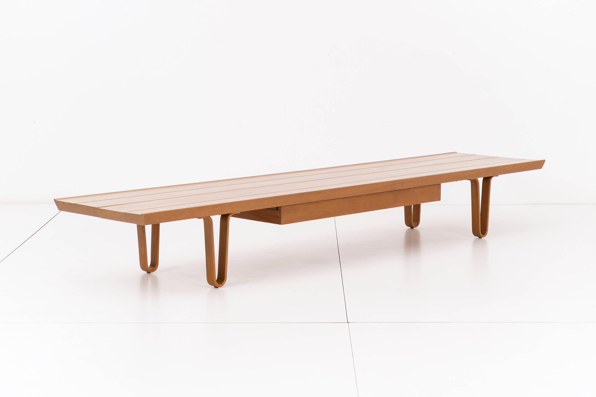Long John bench or coffee table designed by Edward Wormley for Dunbar. Tongue and groove walnut top with drawer, supported by bentwood hairpin legs.
[Gold Label Dunbar].