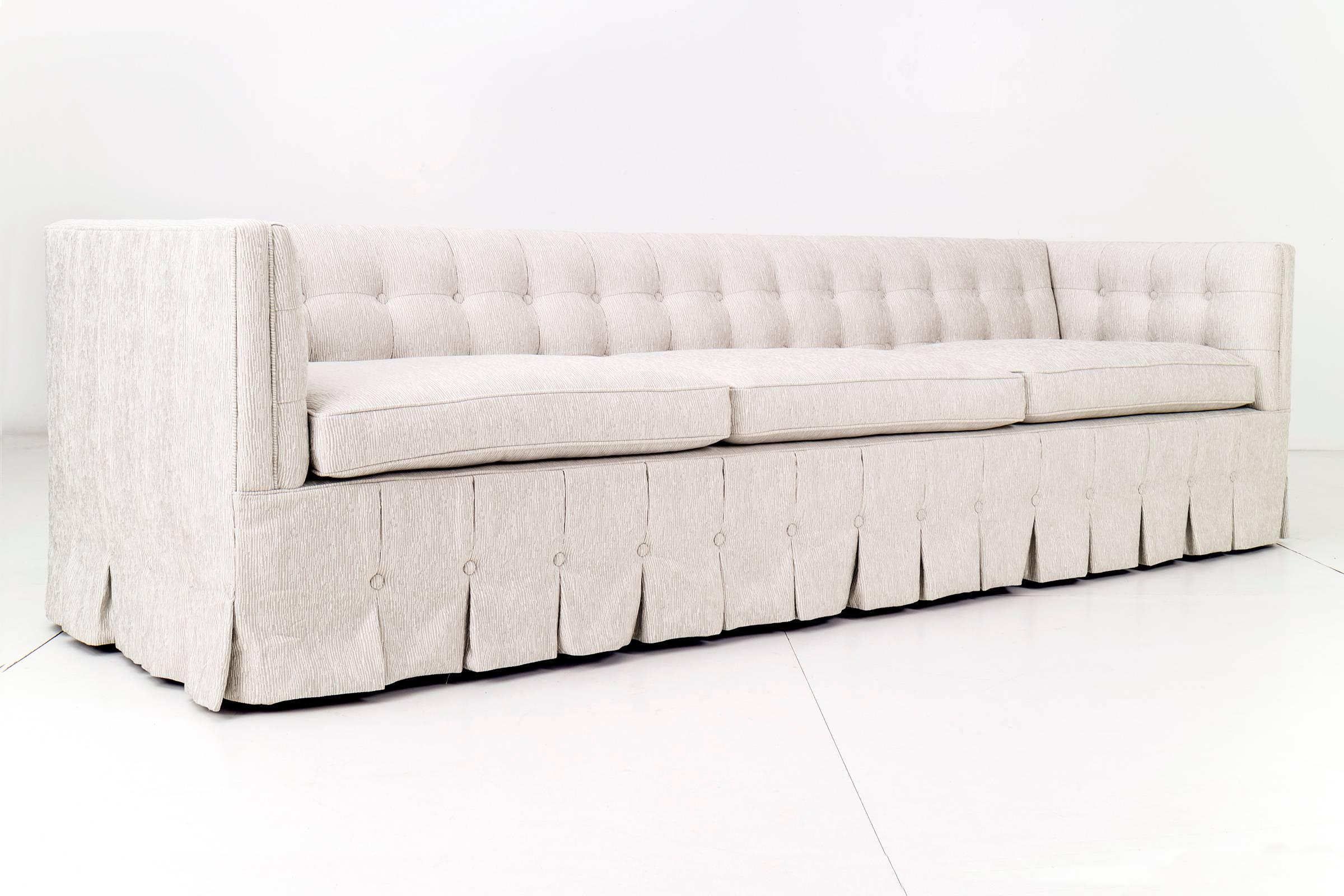 Adeline Stuckey for Kittinger modern, 7000 series biscuit-tufted back and arms Chesterfield sofa, with pleated skirt.
Reupholstered with great plains fabric.
       