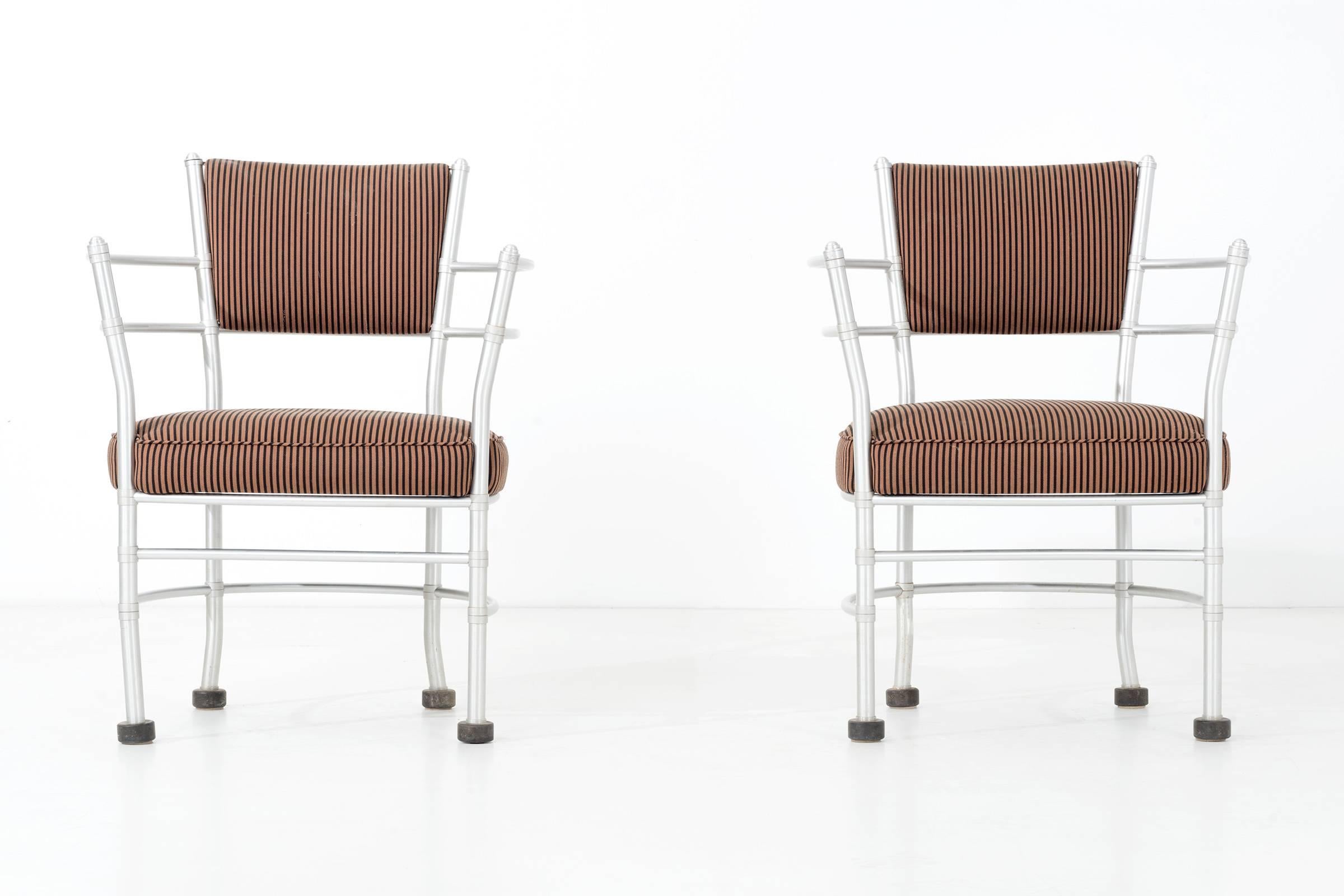 Upholstered aluminum curved back Pull-up chairs with rubber capped feet.