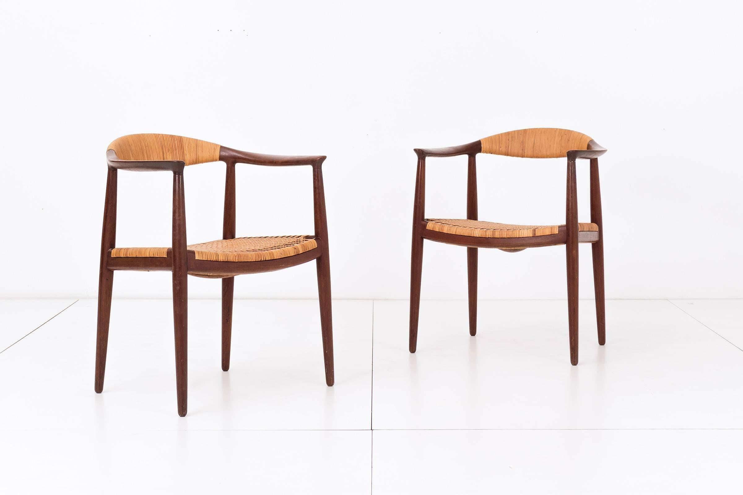 Hans Wegner for Johannes Hansen teak and cane armchairs. 
Signed with branded manufacturer's mark to underside of all examples: [Johannes Hansen Copenhagen, Denmark].
