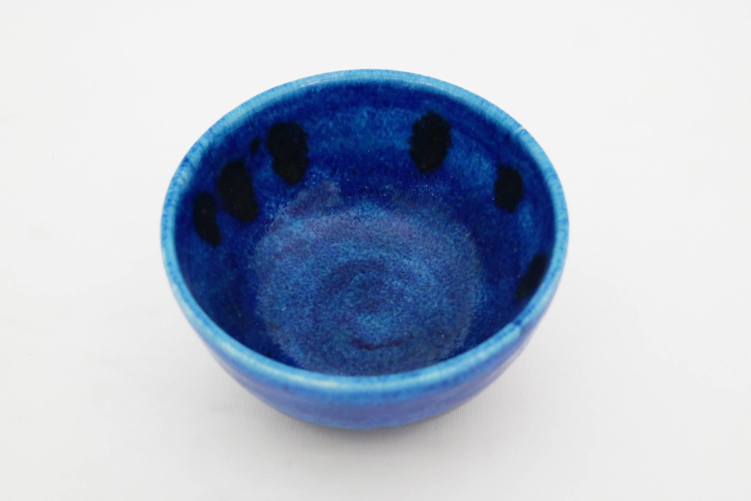 Blue and black glazed ceramic bowl. Signed on underside.