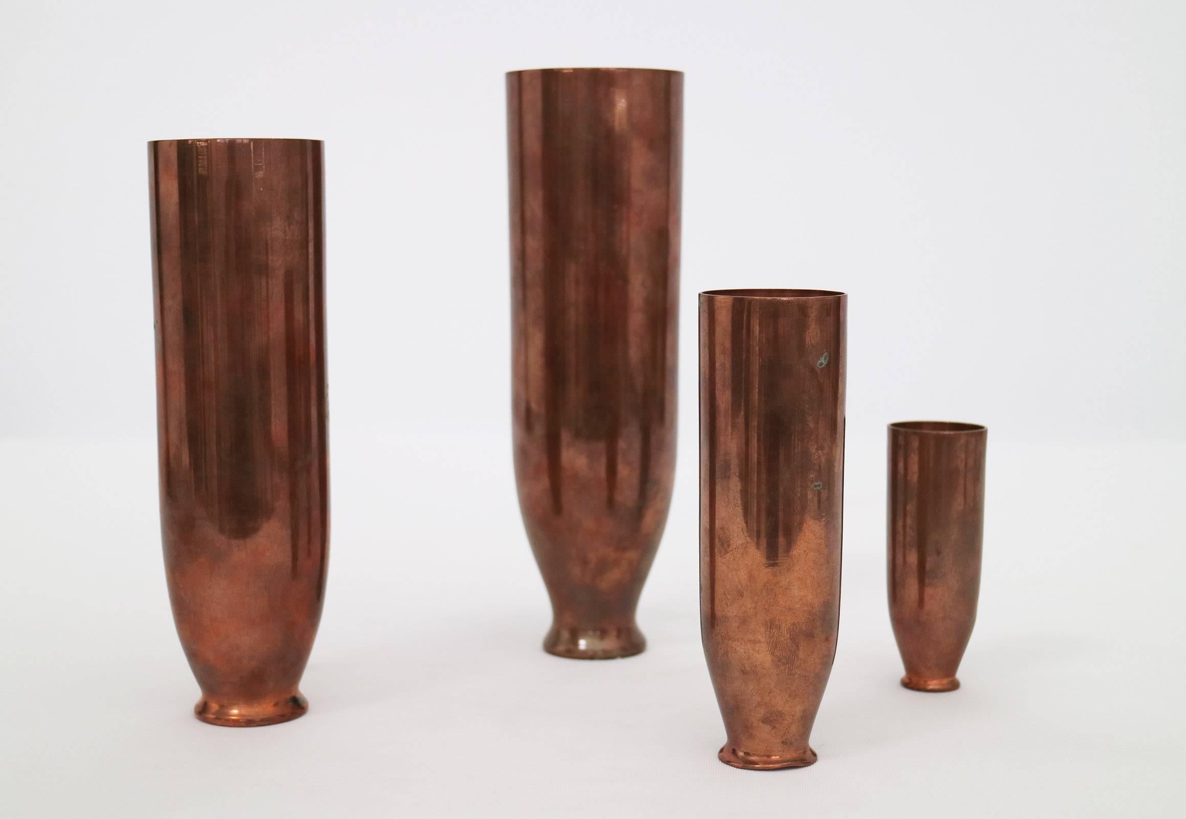 Four copper vases that nest in a matryoshka doll fashion.  Stamped and singed on underside, made in Italy, Faenza.

Dimensions are as follows for the 3 smaller vases.
H: 7.25"
D: 2"

H: 5.5"
D: 1.5"

H: 3.5"
D: