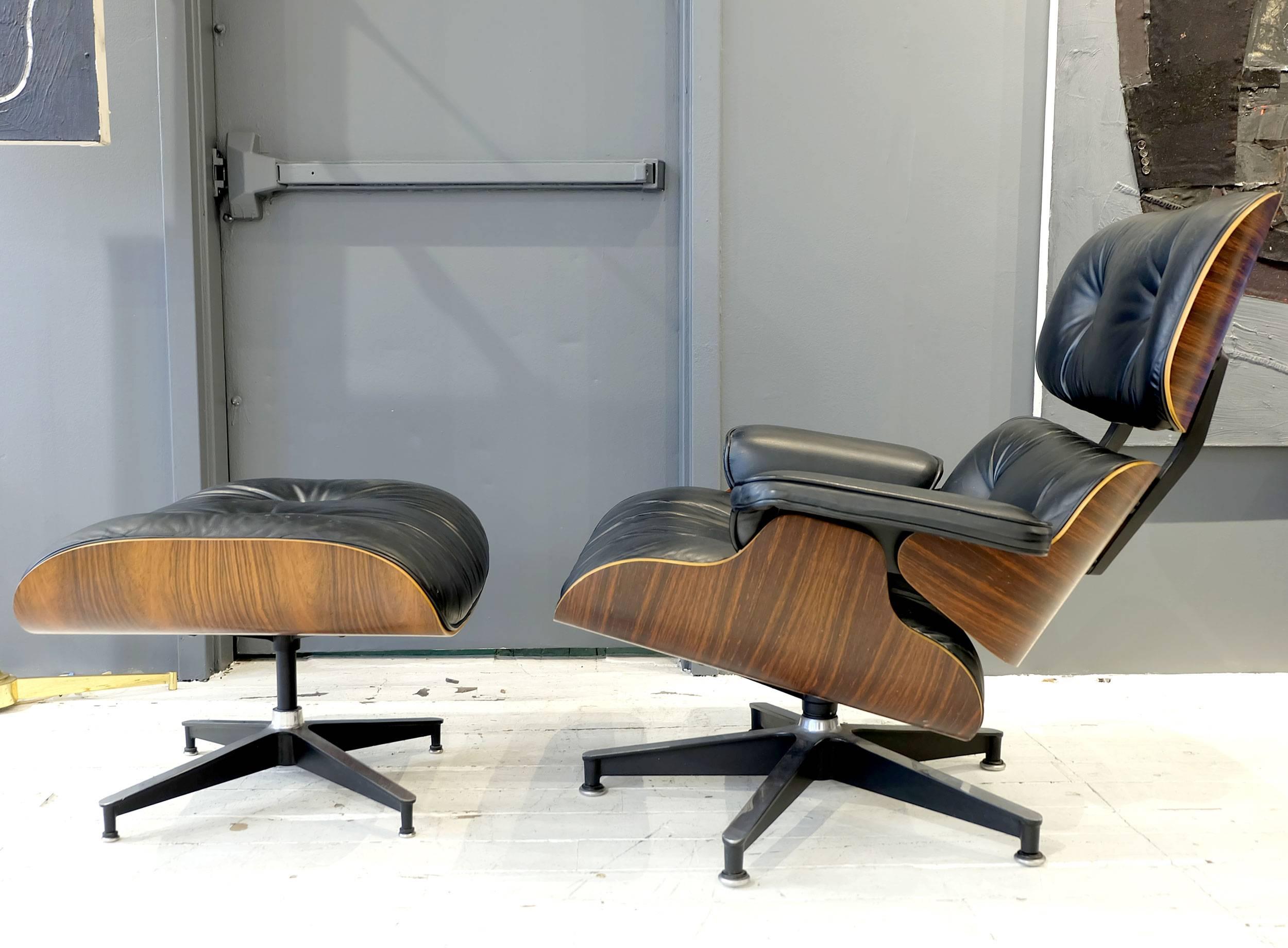 Charles and Ray Eames 670 lounge chair and 671 ottoman darker rosewood oil finish deep figure graining. Ottoman measures: 25.75 W x 22 D x 17 H inches.

This item is currently on view in our NYC Greenwich Street location