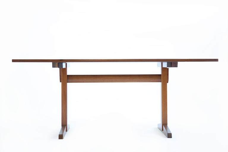 Trestle dining table: Which consists of bookmatched solid boards, with three rosewood butterfly joints, The top is not screwed in like most, it's fits precisely to the base and is secured with pegs (shown in images) The horizontal rail that connects