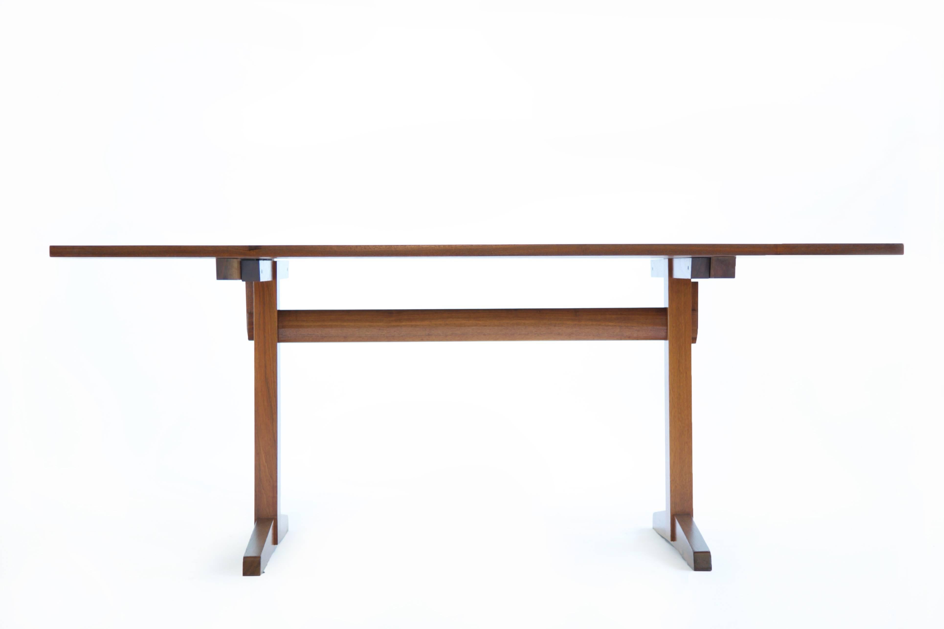 Trestle dining table: Which consists of bookmatched solid boards, with three rosewood butterfly joints, The top is not screwed in like most, it's fits precisely to the base and is secured with pegs (shown in images) The horizontal rail that connects