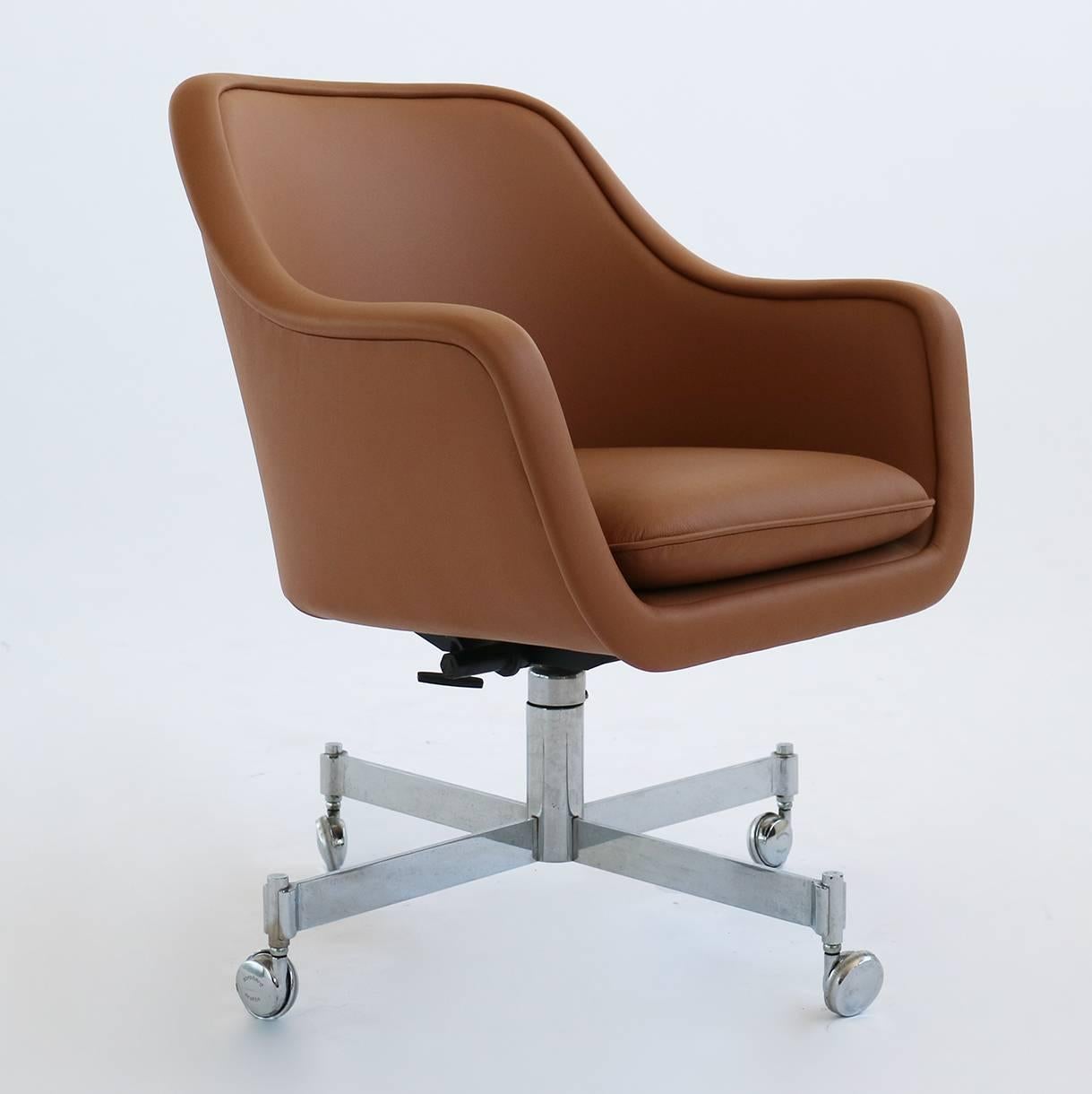 Desk chair by Ward Bennett. Reupholstered in a tan colored leather. The base, tilts, swivels, and has an adjustable height.  Arm Height is 25.5