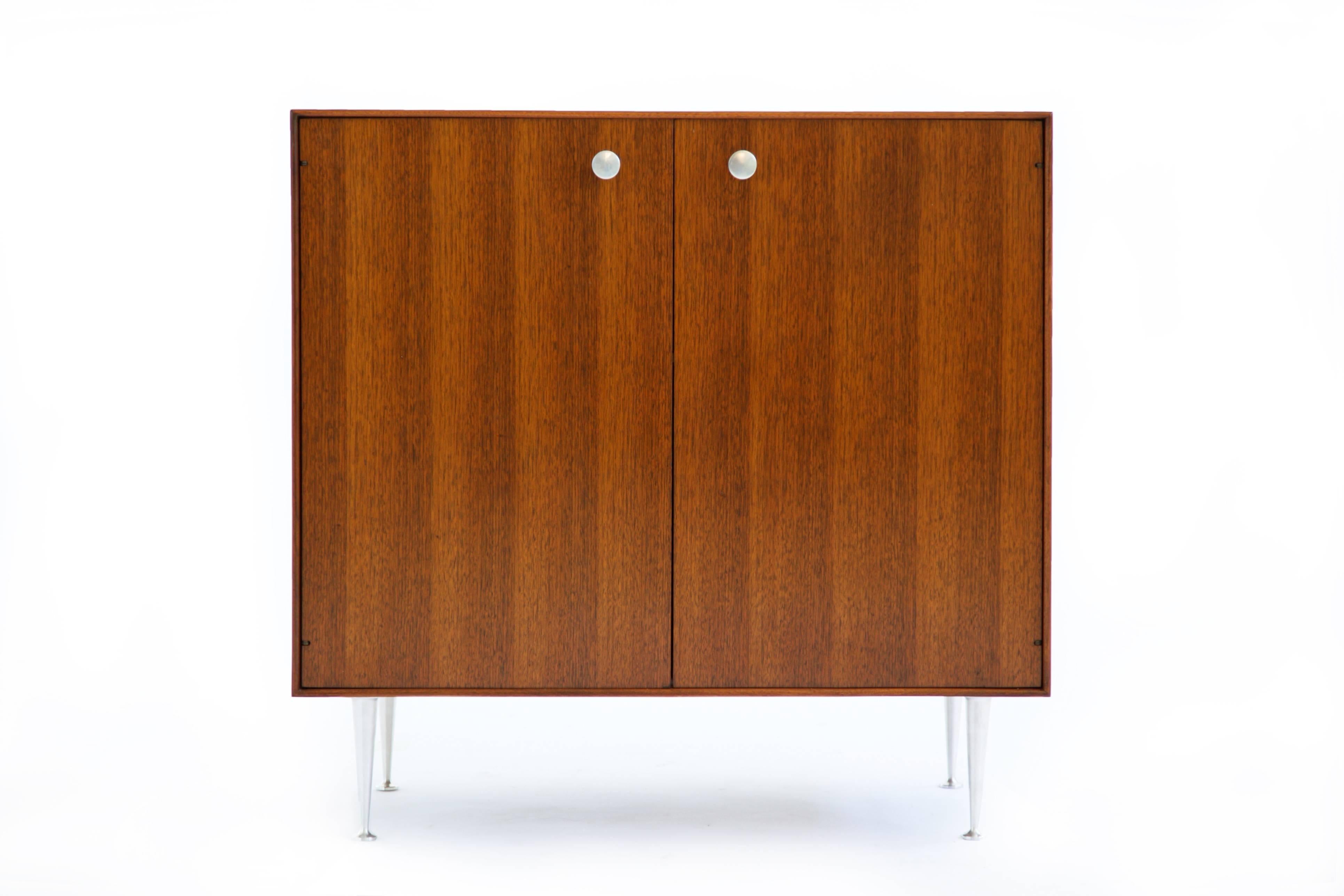 Nelson for Herman Miller Case, Quarter-sawn black walnut with aluminum pulls and tapered legs and adjustable shelf.  

