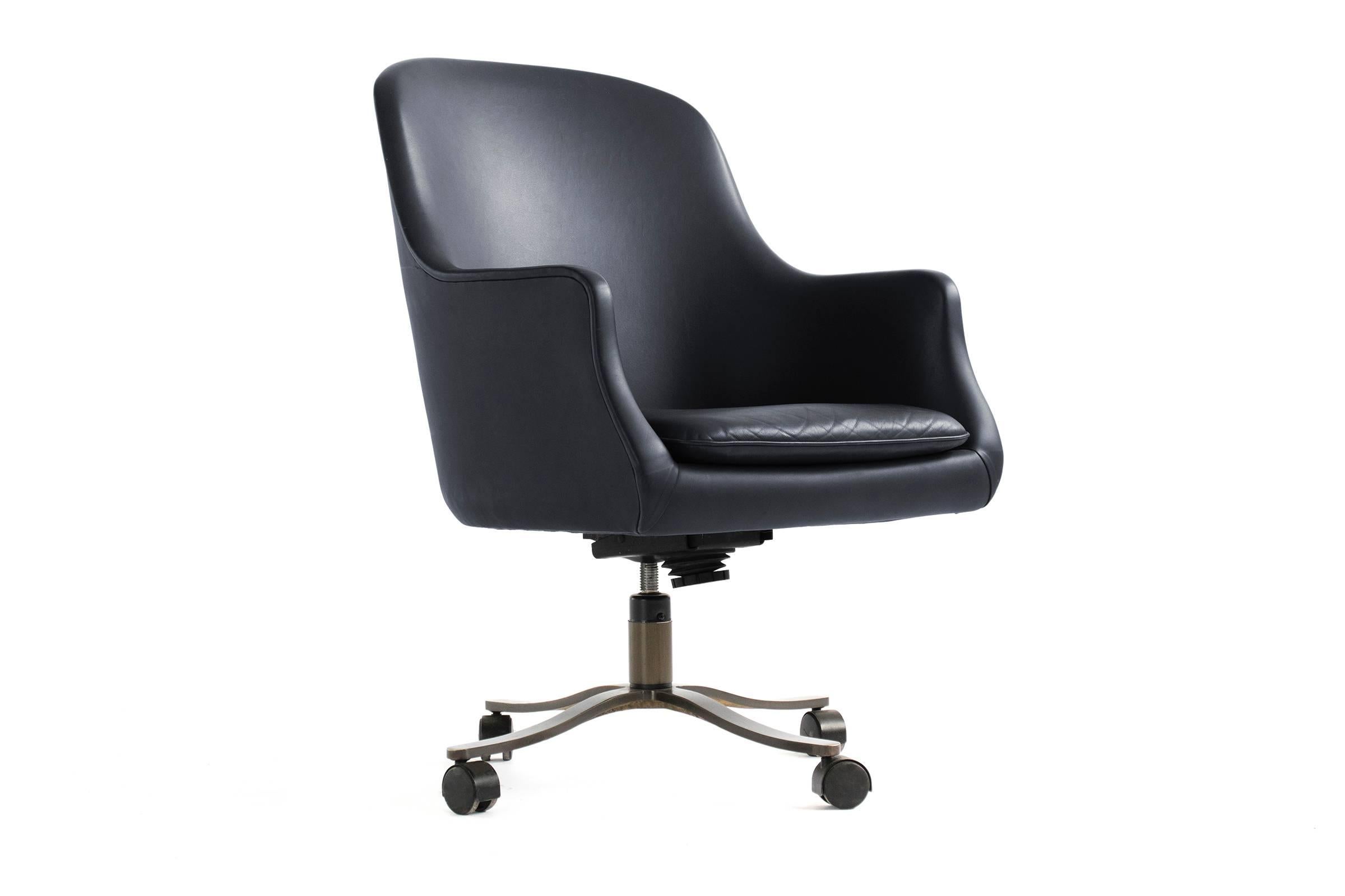 Upholstered navy leather desk chair. Dark bronze four-star base with casters. Adjustable height and tilt sensitivity.
More available.