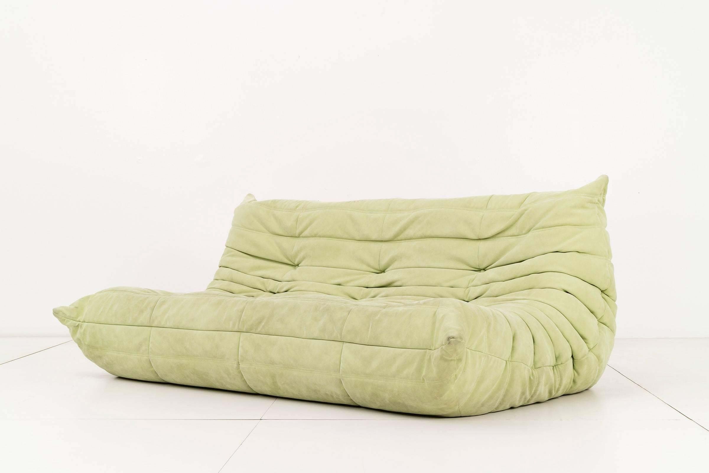 Michel Ducaroy for Ligne Roset. Pair of three-seat sofas upholstered in a faded lime suede. Original label on back [Made In France, Ligne Roset].
 