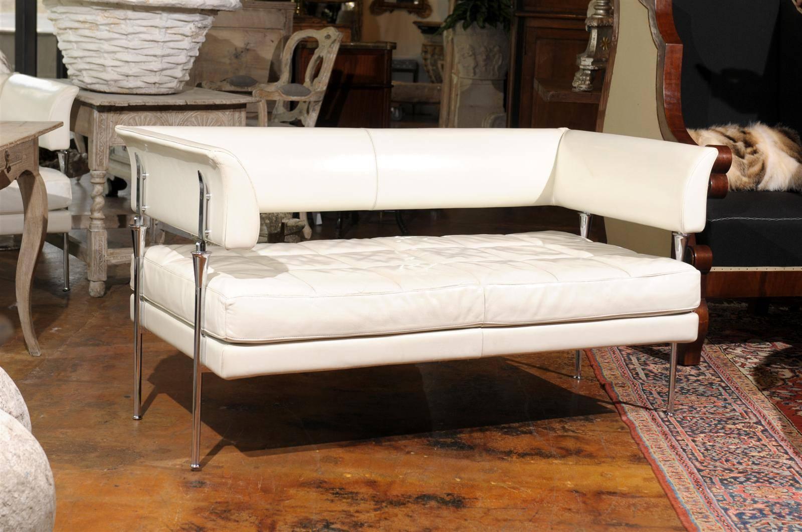 Luca Scacchetti and Poltrana Frau Italian leather settee, the open wrap around back with box quilt La Pelle leather over a tufted conforming seat, raised on straight chrome legs. 

Poltrona Frau was founded in 1912 in Turin and the company became