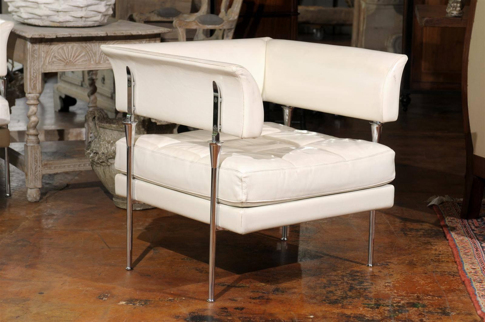 This pair of Italian Hydra Castor armchairs were designed by renowned artist Luca Scacchetti in 1992 for Poltrona Frau, the famed Italian furniture firm. The chairs are upholstered in a high quality white Pelle leather. The wrap-around backs and