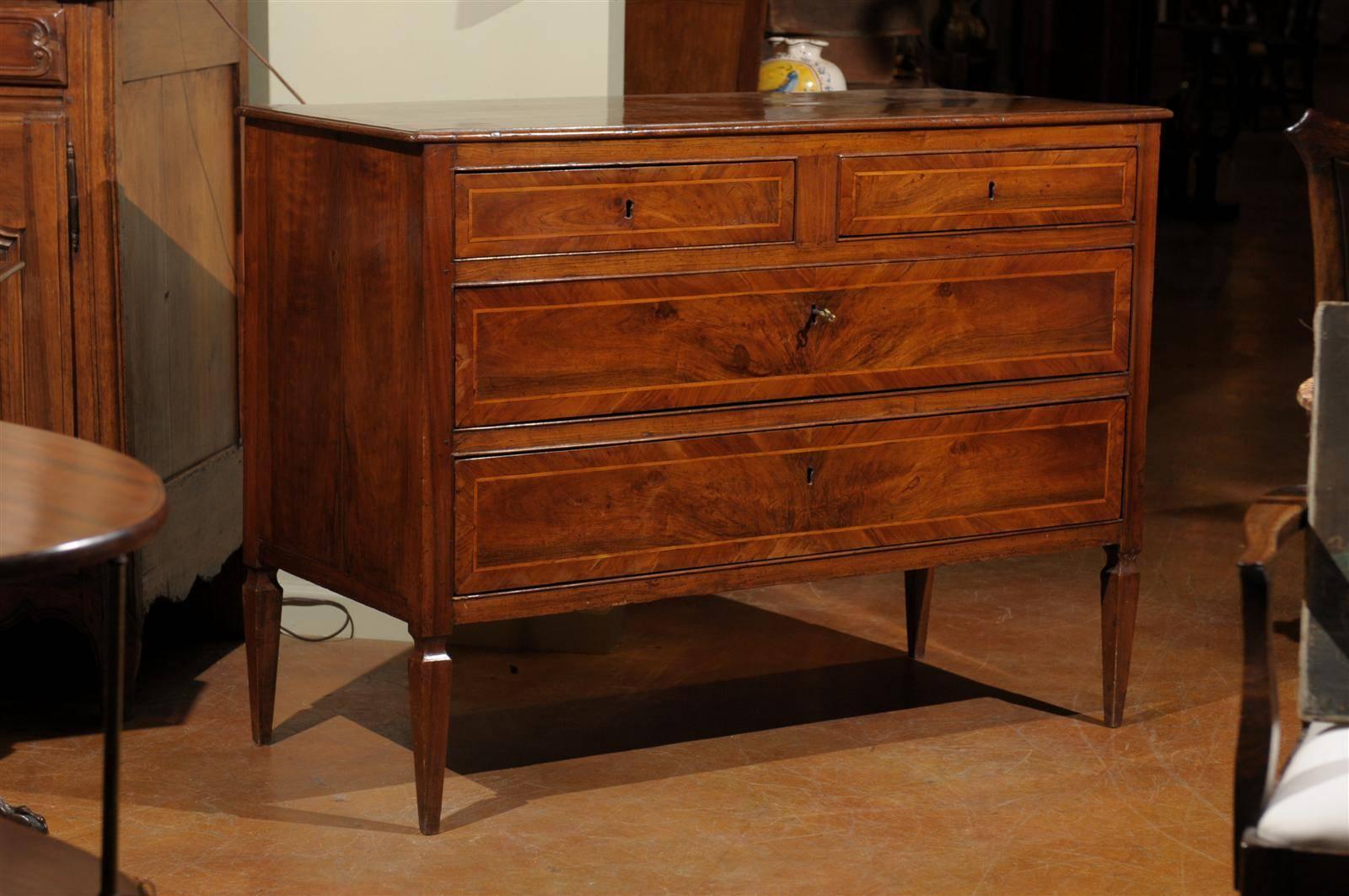 18th century Italian walnut commode, the rectangular top surmounting two inlaid short drawers above two inlaid long drawers, raised on tapering legs. Comes with working locks and keys.