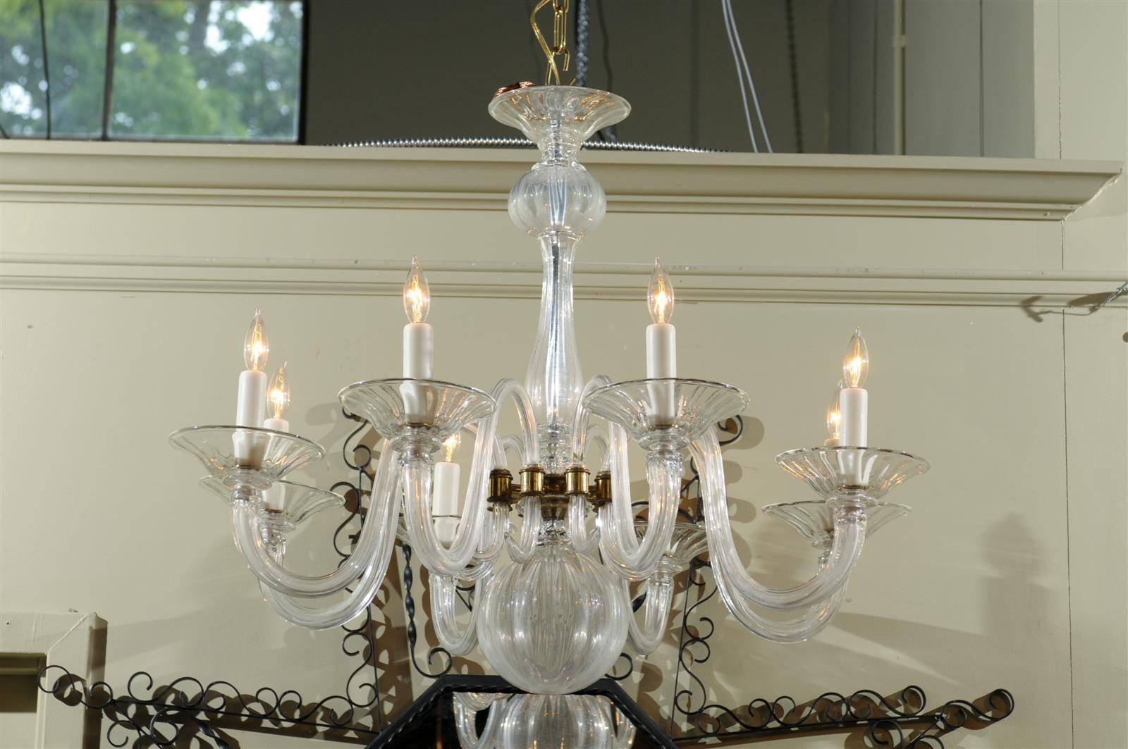 Mid 20th century eight-light Murano chandelier with scrolling arms ending in bell-form bobeches supported by a globular-form center, with gilt accents throughout.
