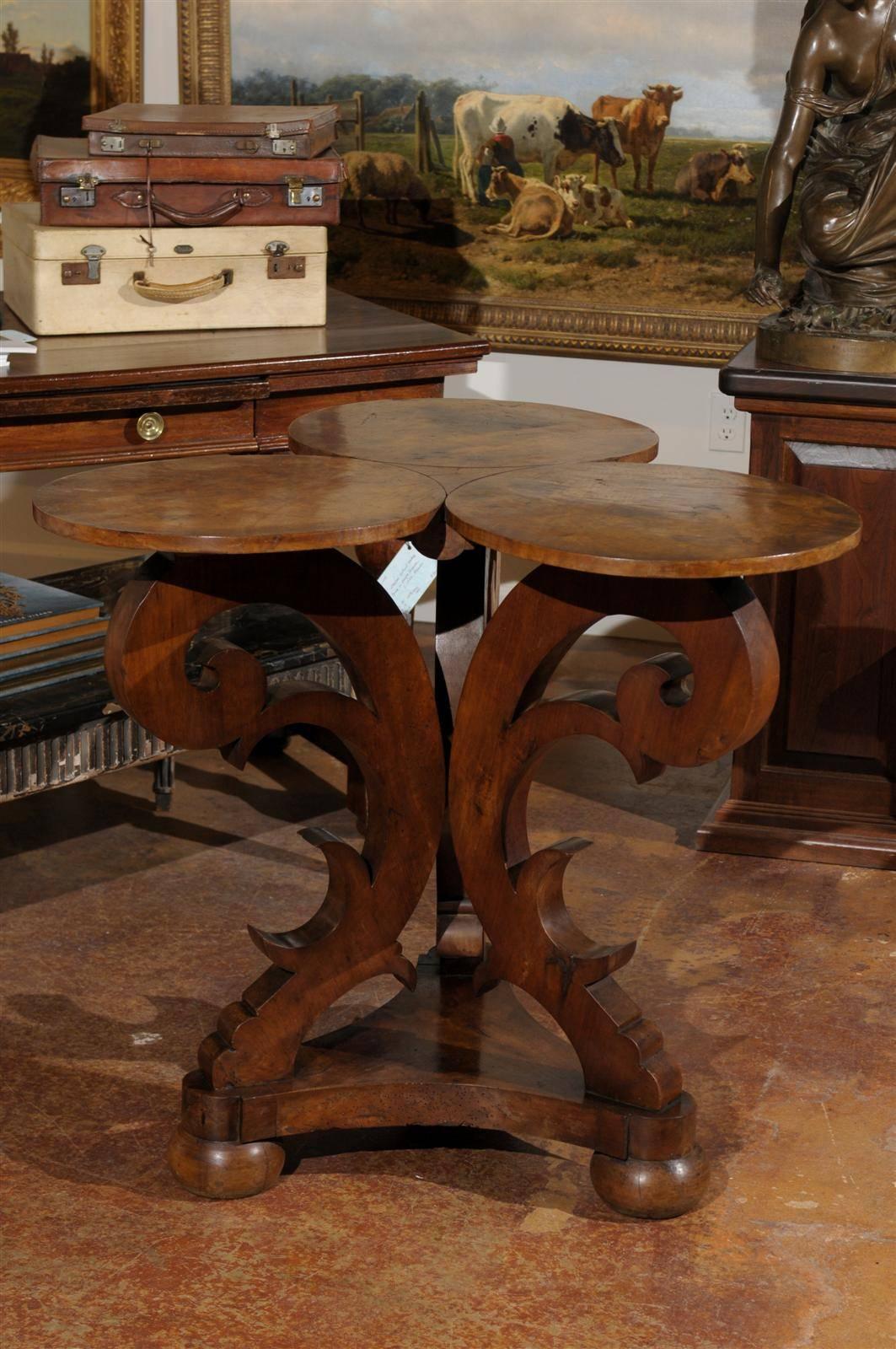 Late 19th to early 20th century Italian carved walnut table with triple circular top raised on a gracefully carved tripod base ending in a single stretcher and squat feet.